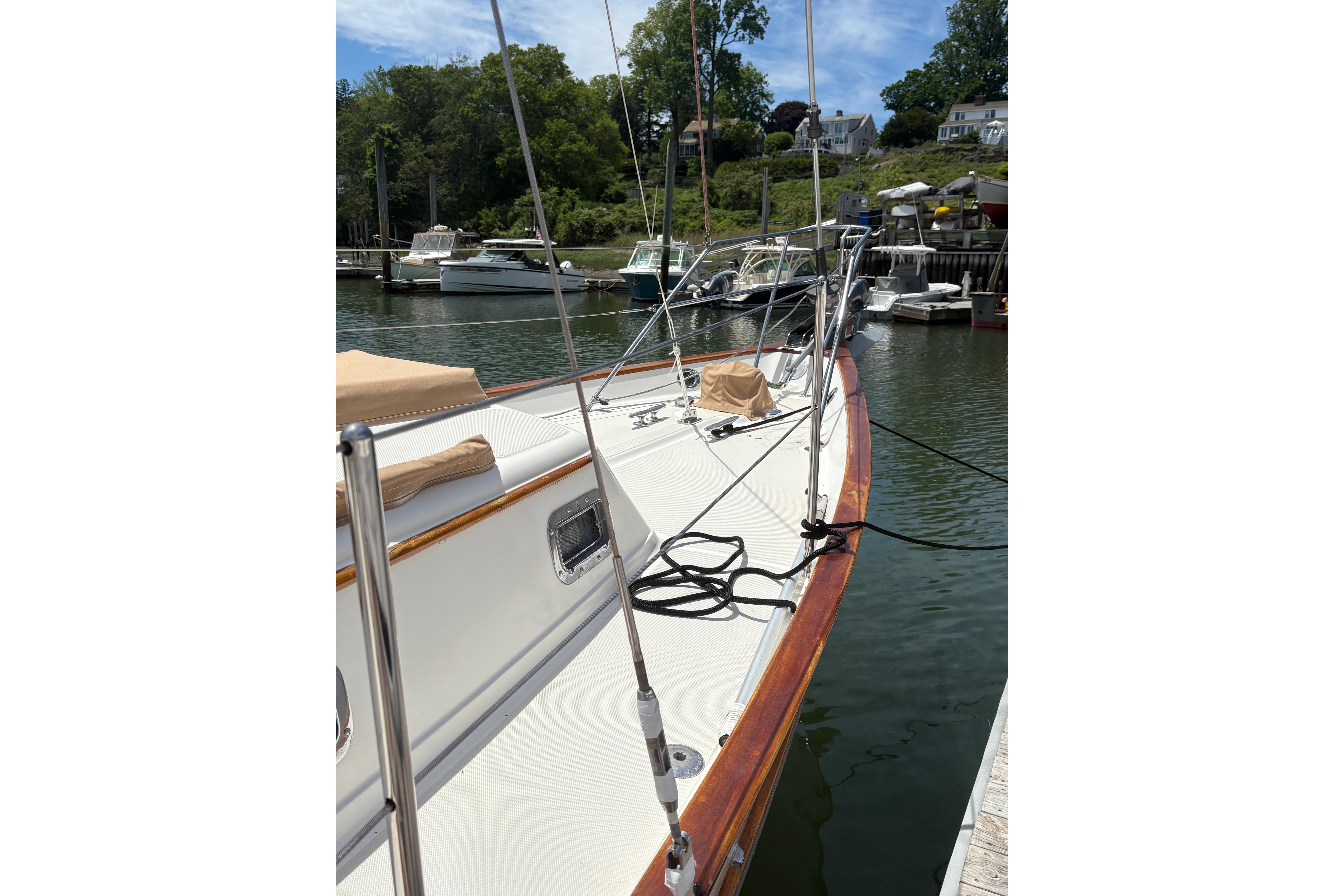 1997 Pacific Seacraft Crealock 34 sailboat docked in a serene marina setting.