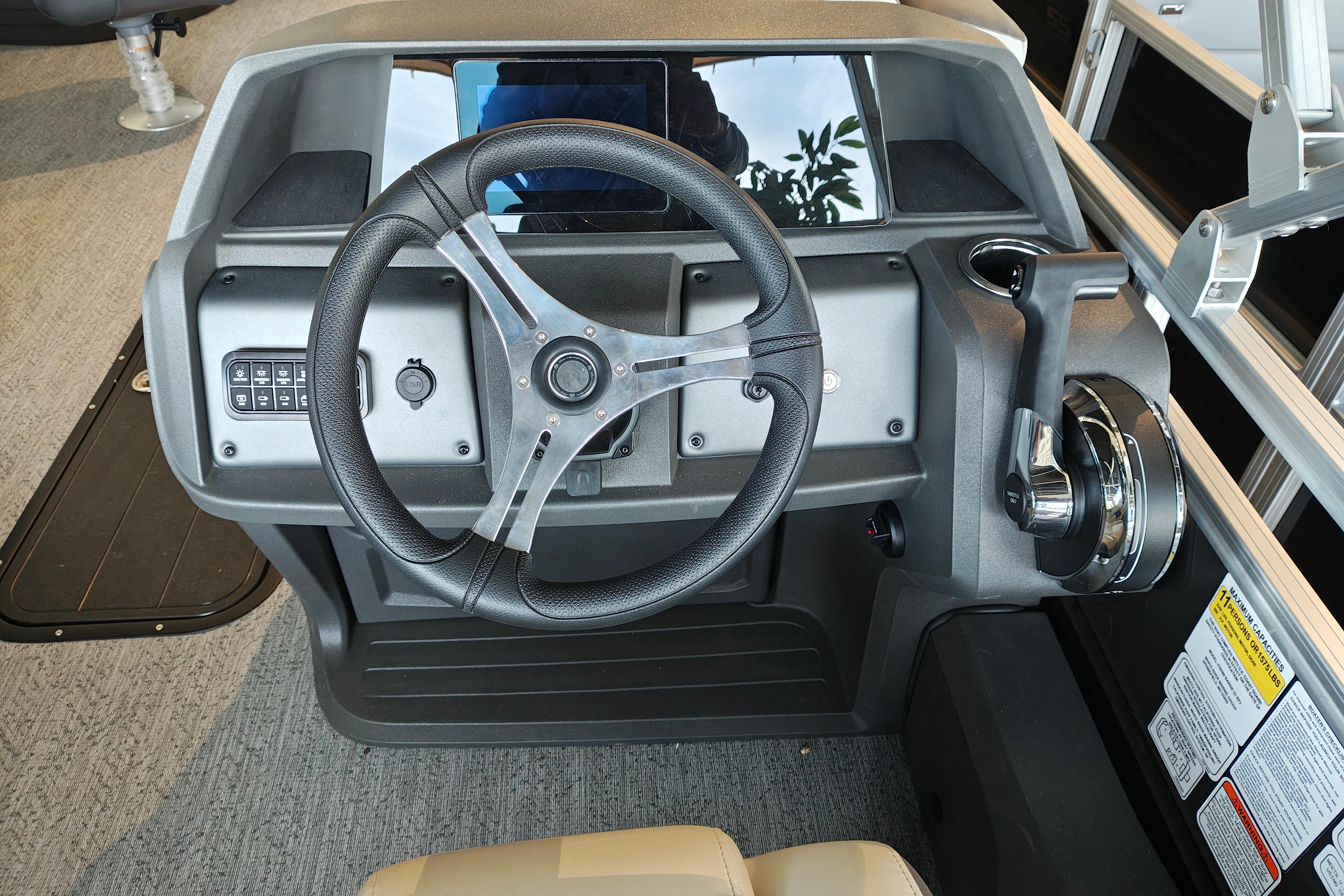 Steering console of 2026 Sun Tracker Fishin' Barge 22 XP3, featuring modern controls and design.