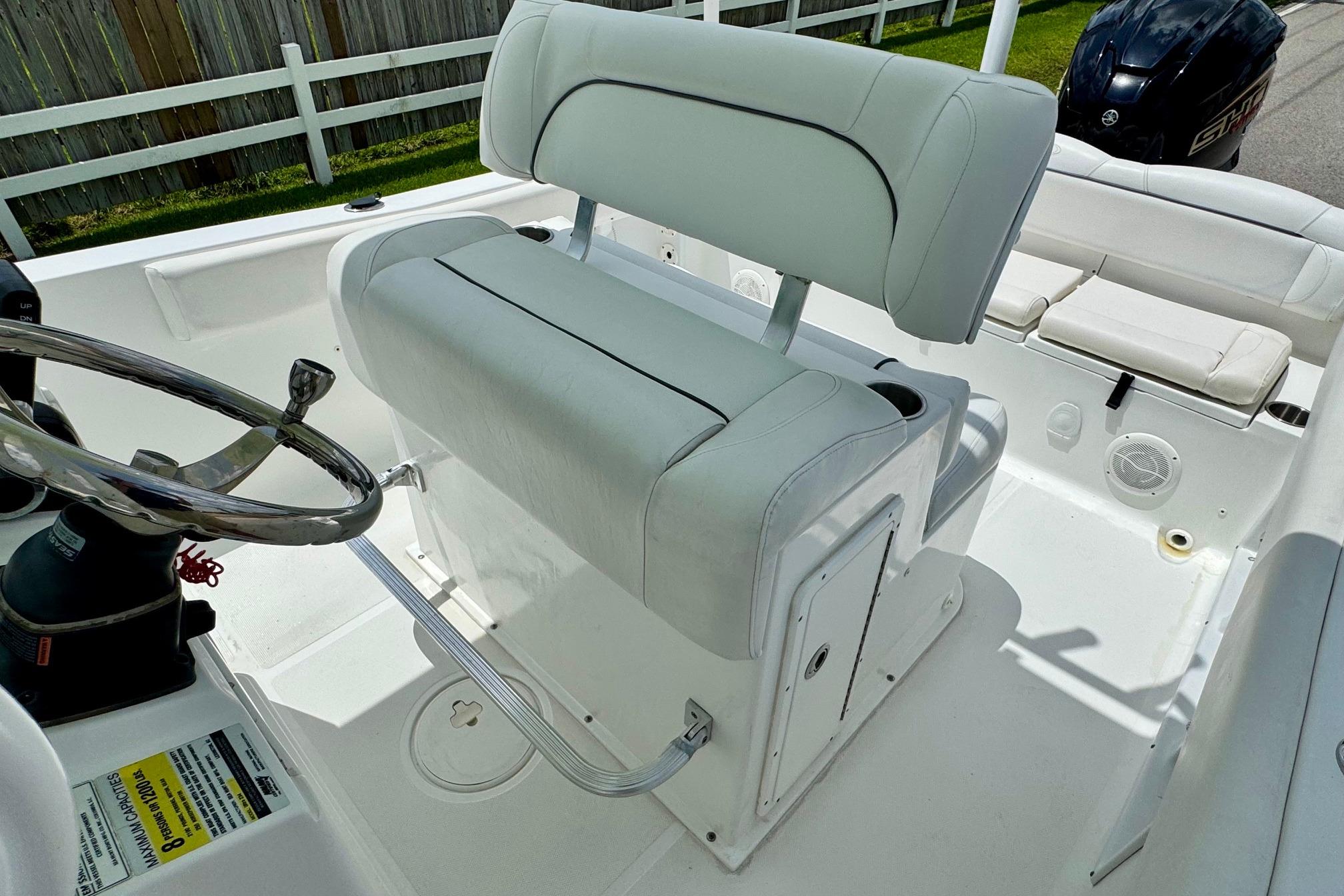2015 Sea Hunt Ultra 234 boat interior with white seating and steering wheel.