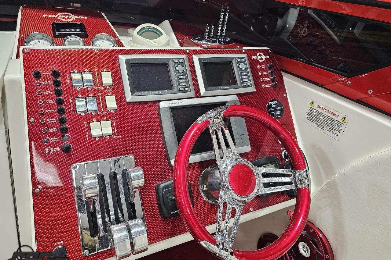 Dashboard of a 2009 Fountain 47 Lightning boat with red accents and navigation controls.