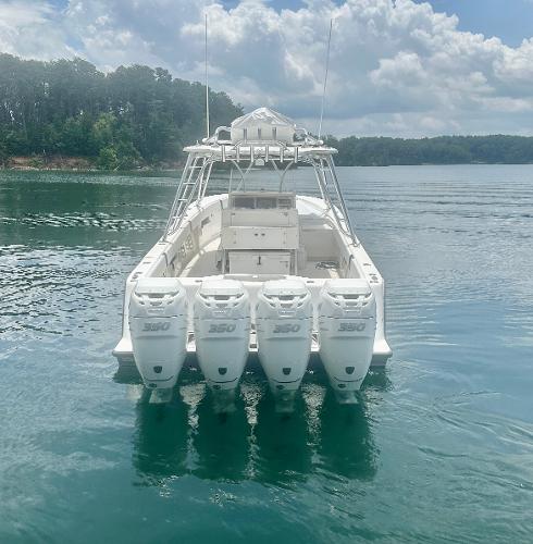 2008 SeaVee 390B boat with four powerful engines on a calm lake.