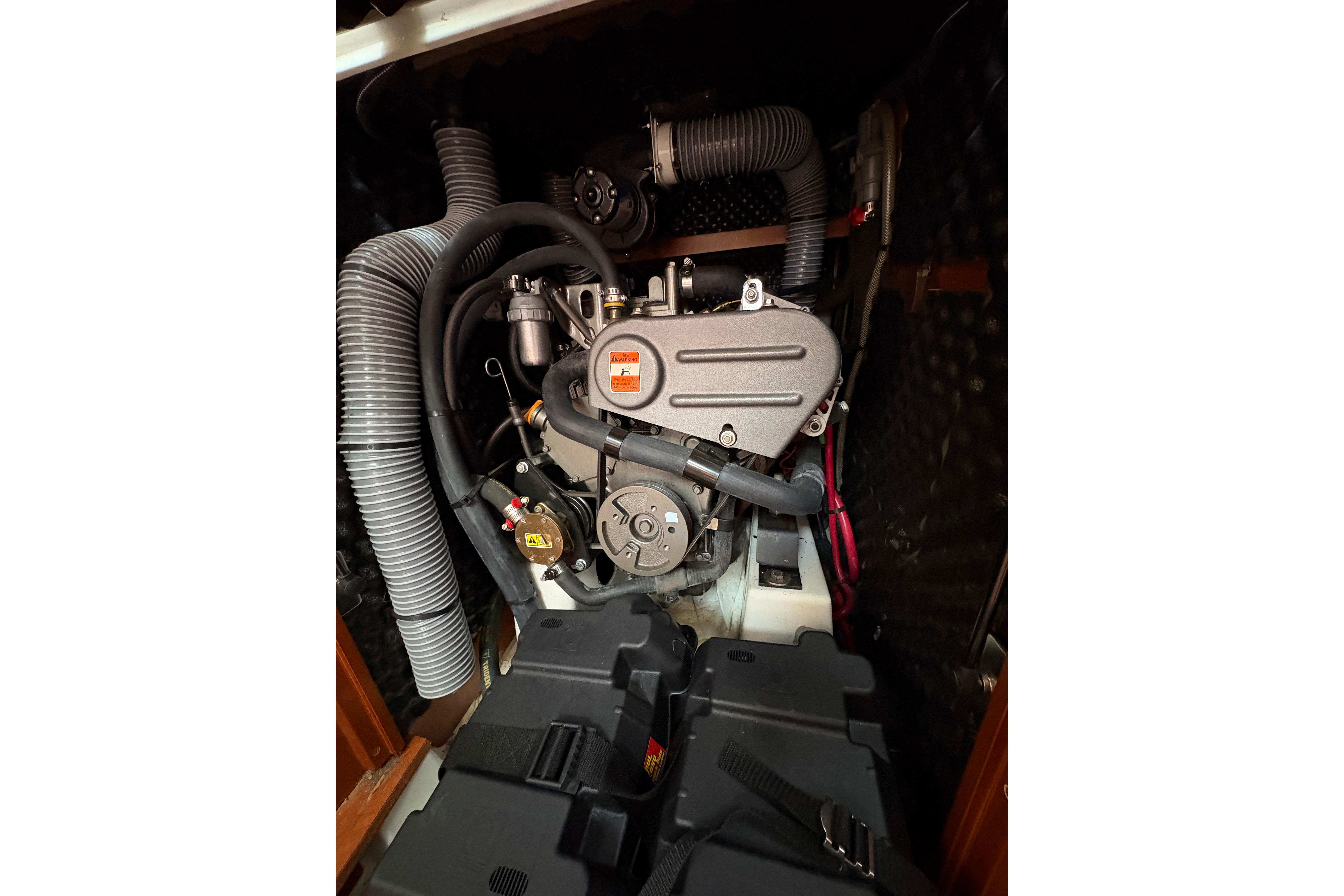 Engine compartment of a 2015 Beneteau Oceanis 34 sailboat, showcasing mechanical components.