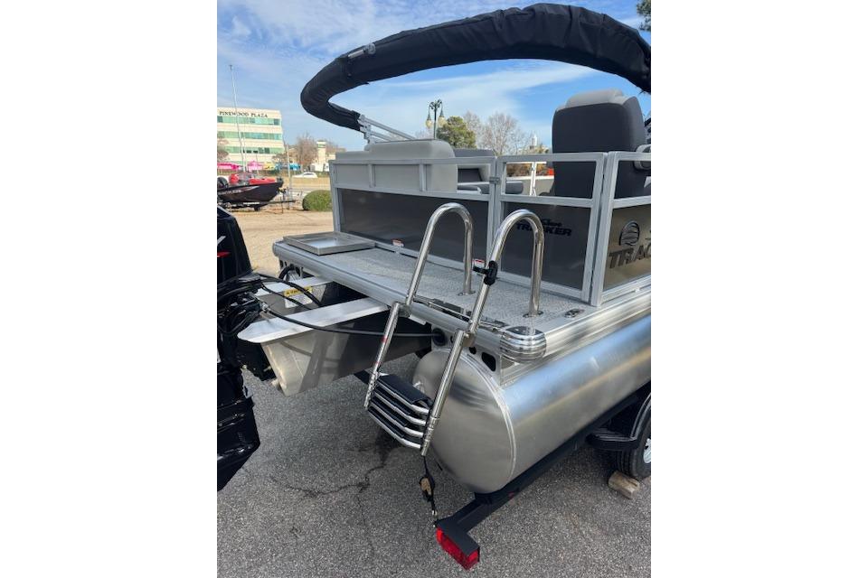 2026 Sun Tracker Bass Buggy 16 XL Select pontoon boat with rear ladder and seating.