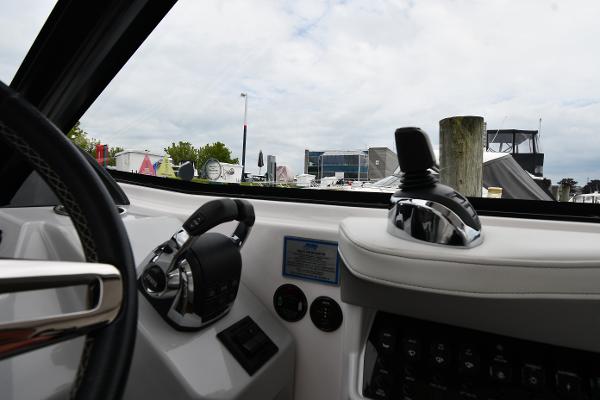 Interior view of 2021 Regal 35 Sport Coupe boat cockpit with steering and controls.