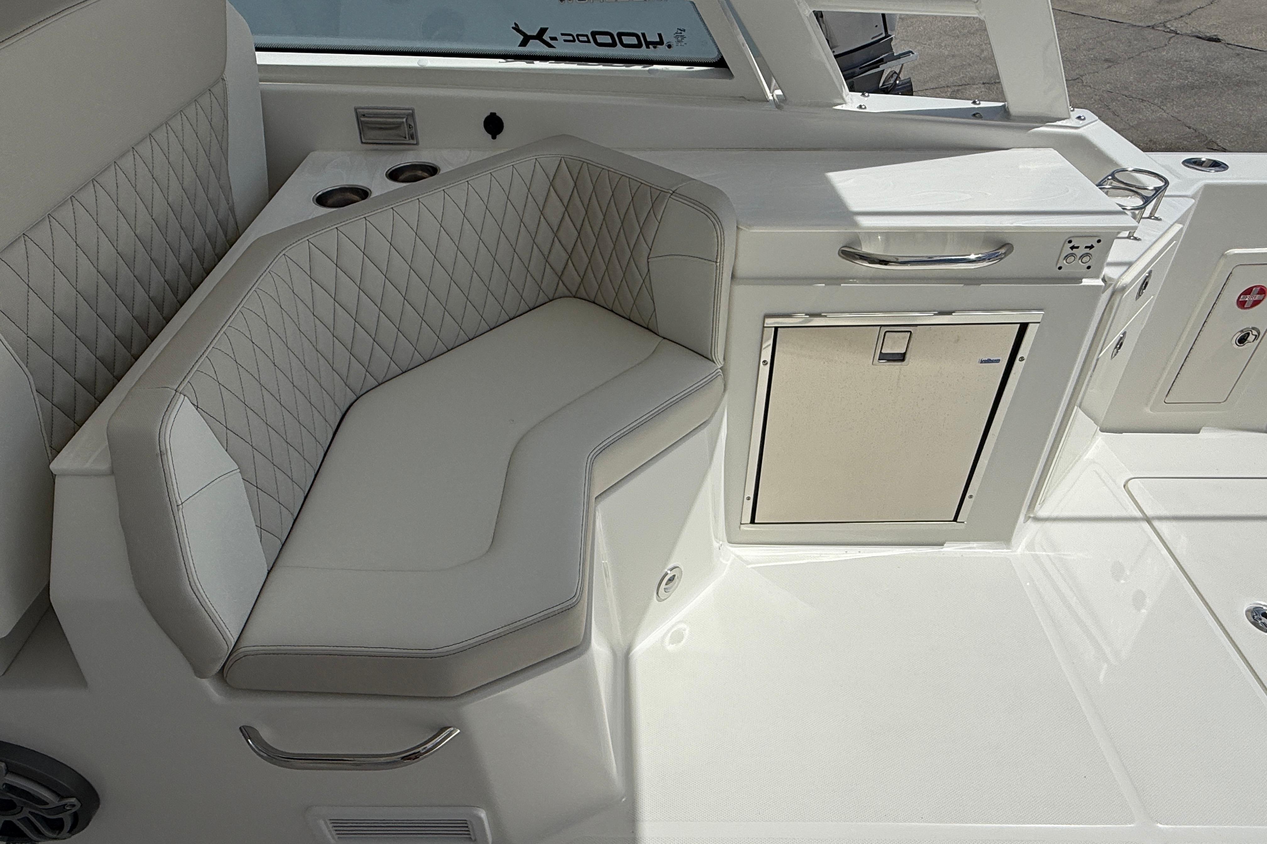 Luxurious seating area on 2026 World Cat 400 DC-X Island boat with quilted upholstery.