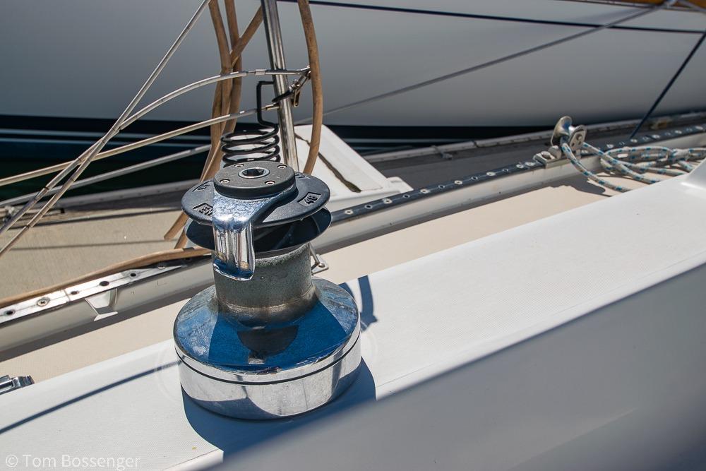 Winch on 1984 Catalina 36 sailboat deck, with rigging and ropes visible.