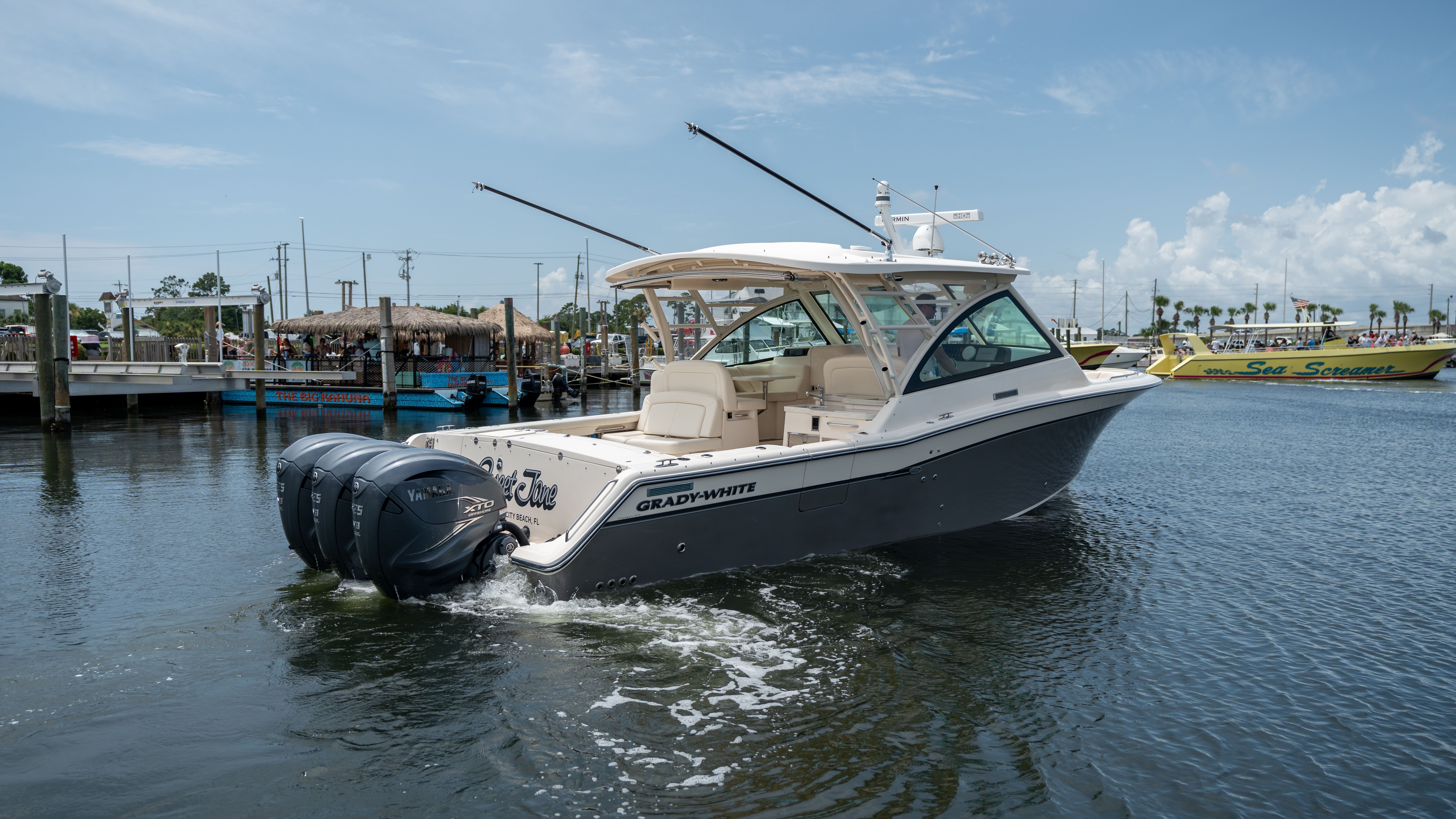 2019 Grady-White 375 Freedom on the water with three outboard engines.