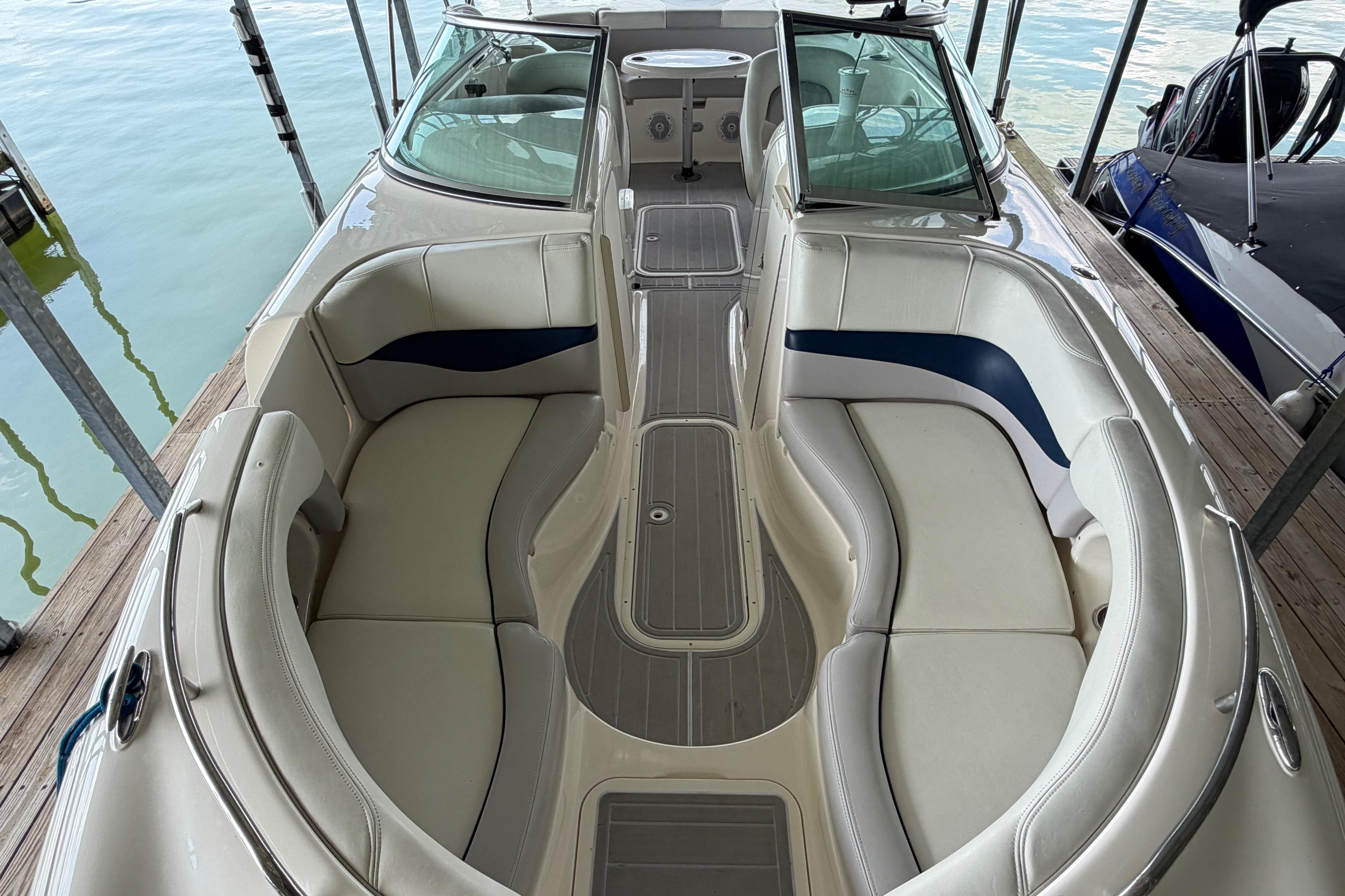 Interior view of a 2010 Bryant 255 boat with spacious seating and sleek design.