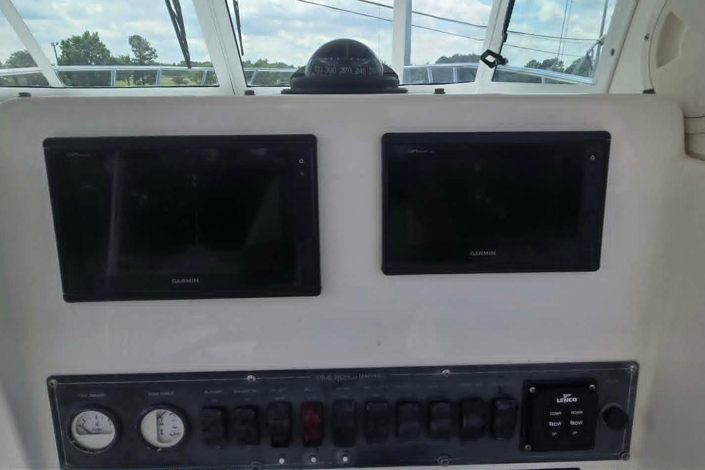 Control panel of a 2003 True World Marine 286 boat with Garmin displays.