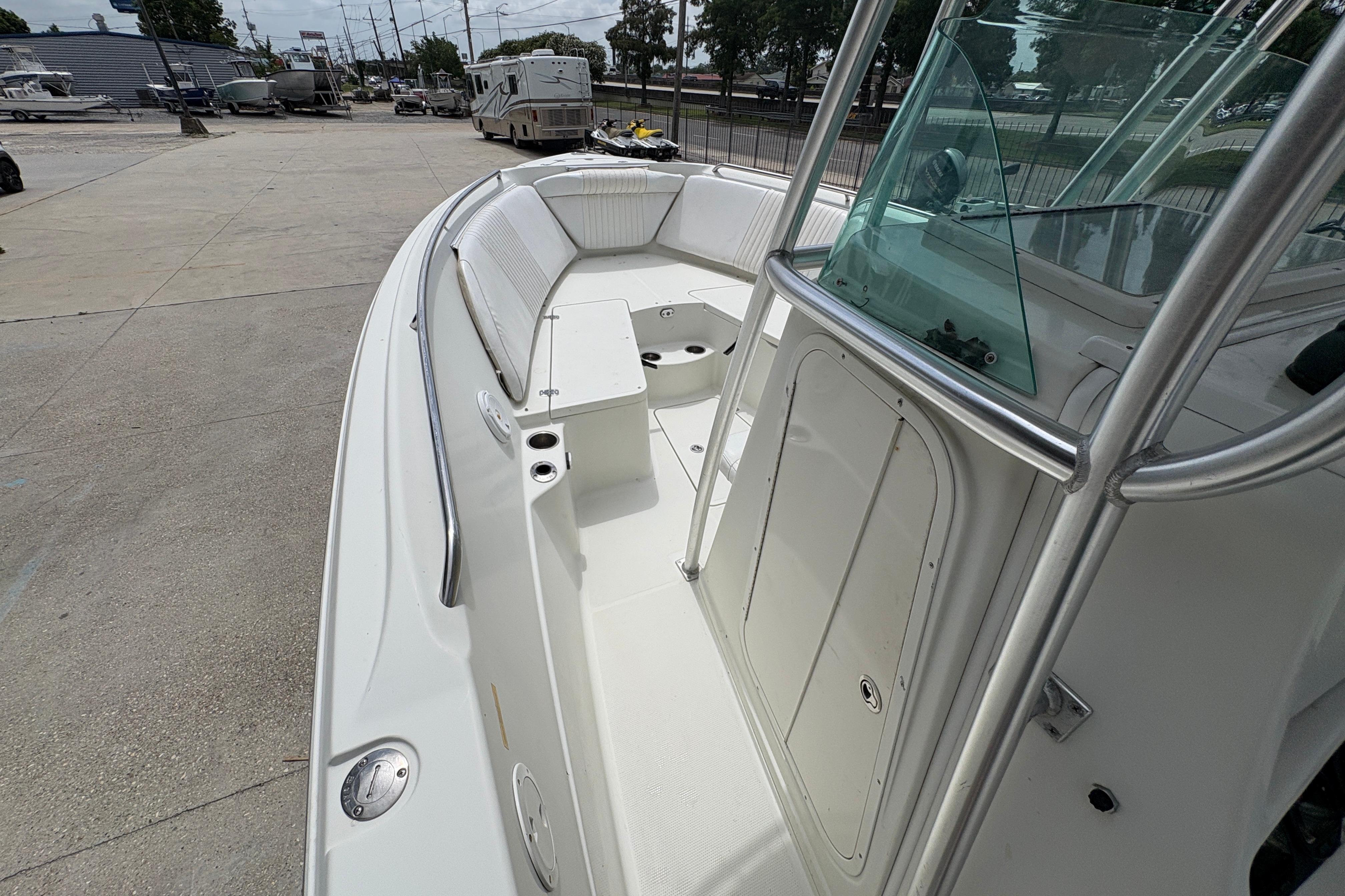 2006 Sail Faish 2360 boat with spacious deck and seating, parked outdoors.
