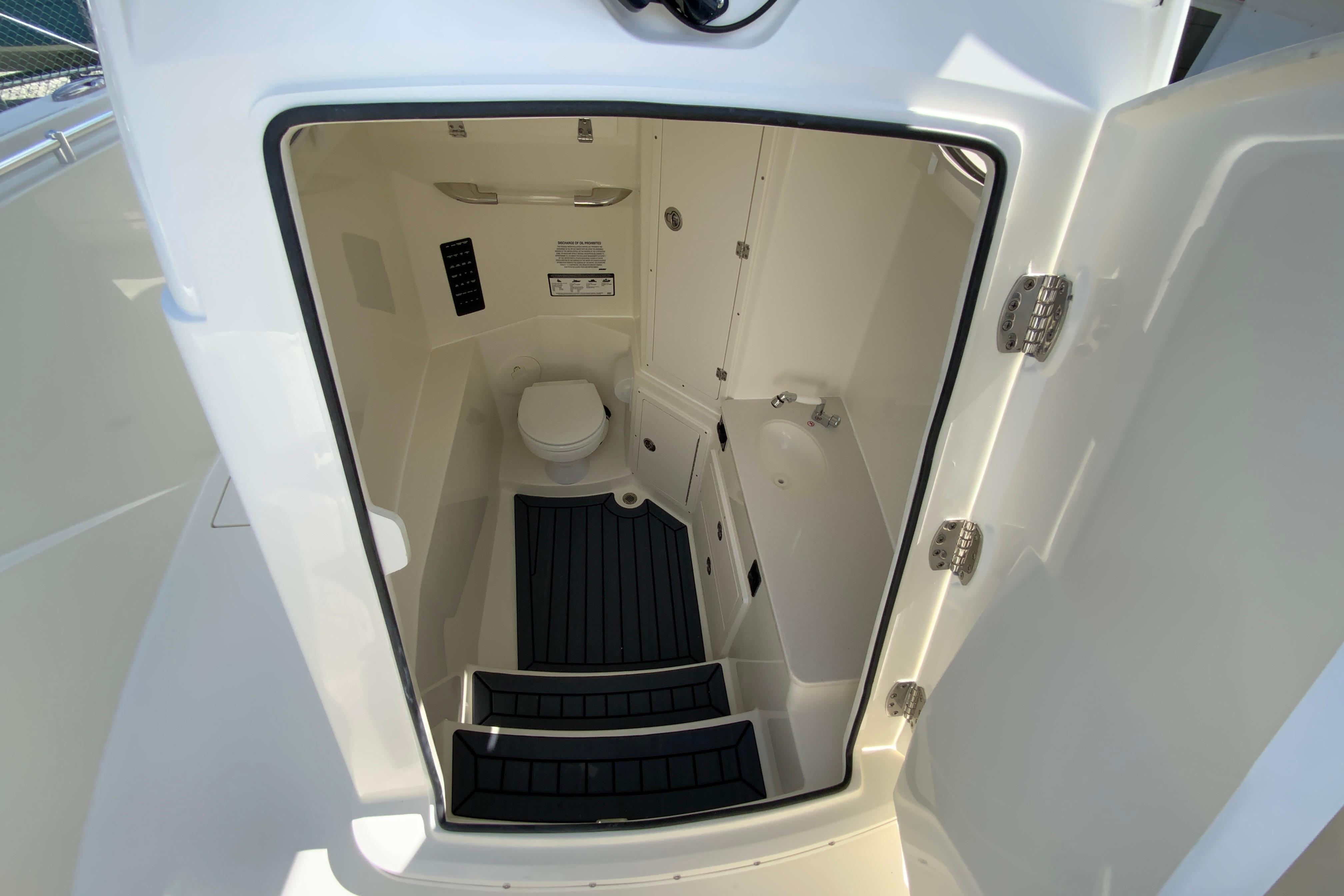 Interior view of 2027 Cobia 320 Center Console boat's compact bathroom.