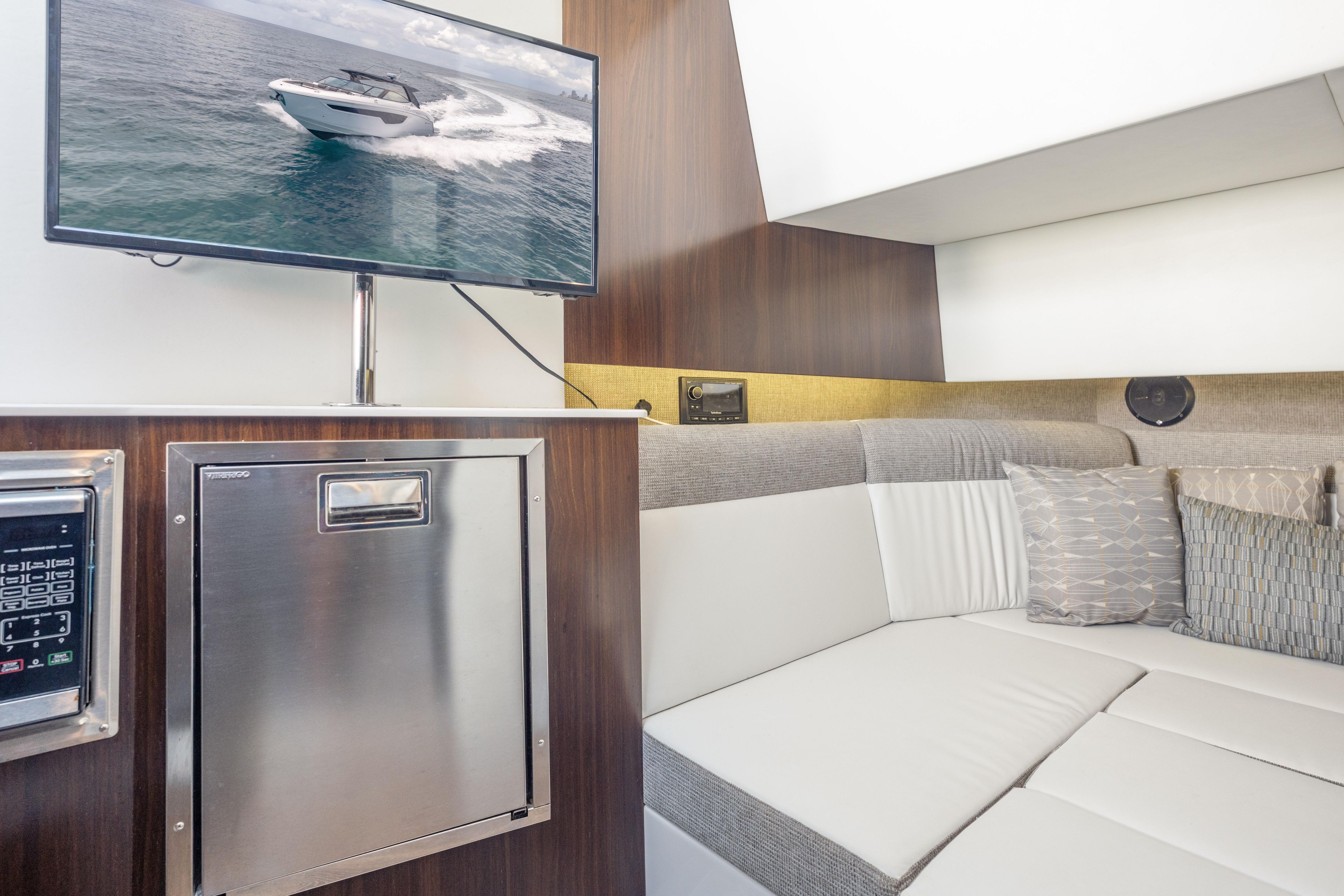 Interior of 2021 Cruisers Yachts 38 GLS with TV and modern seating area.