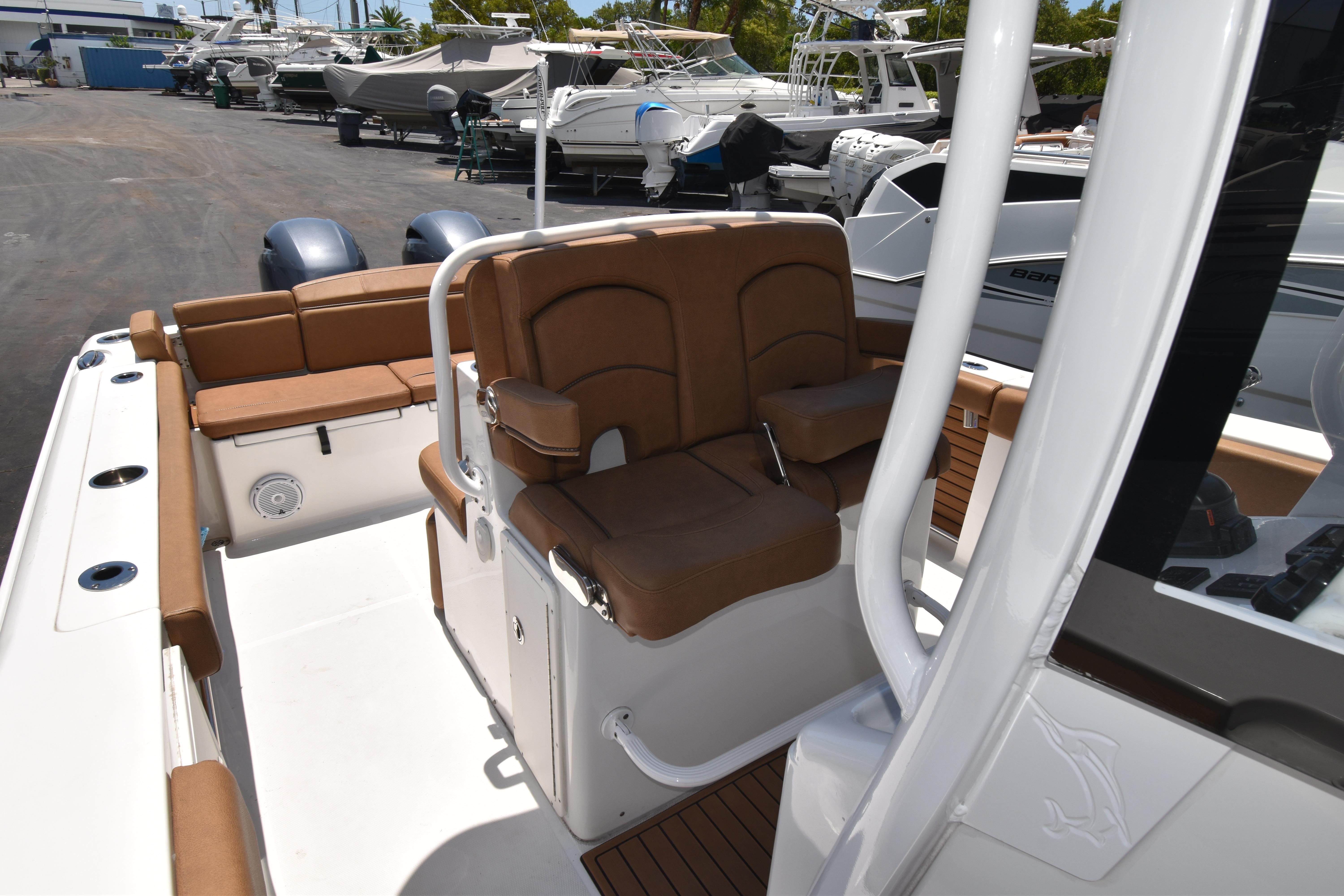 2020 Sea Hunt Ultra 275 SE boat interior with brown seating and dual engines.
