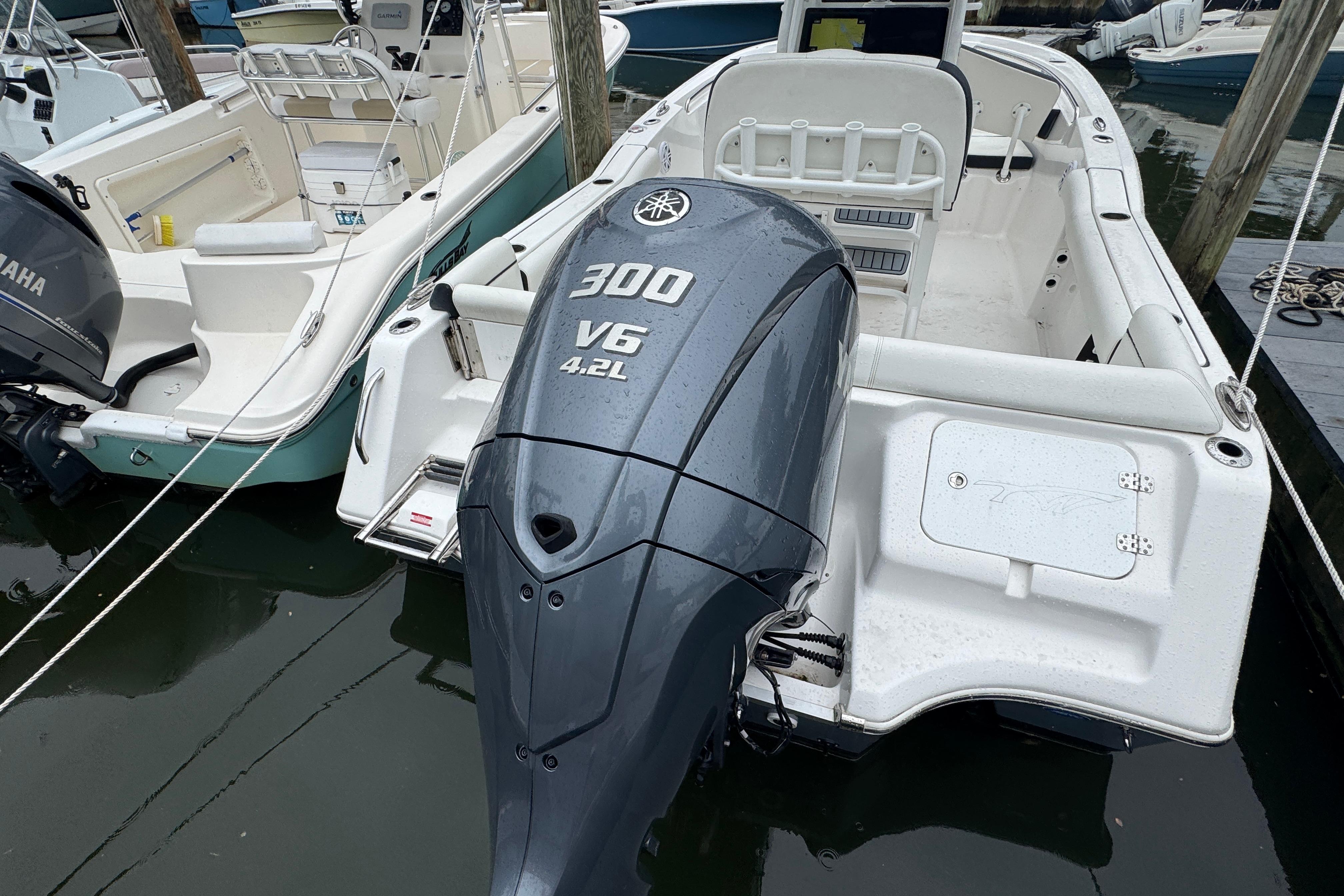 2022 Tidewater 232 SS boat with Yamaha 300 V6 engine docked in marina.
