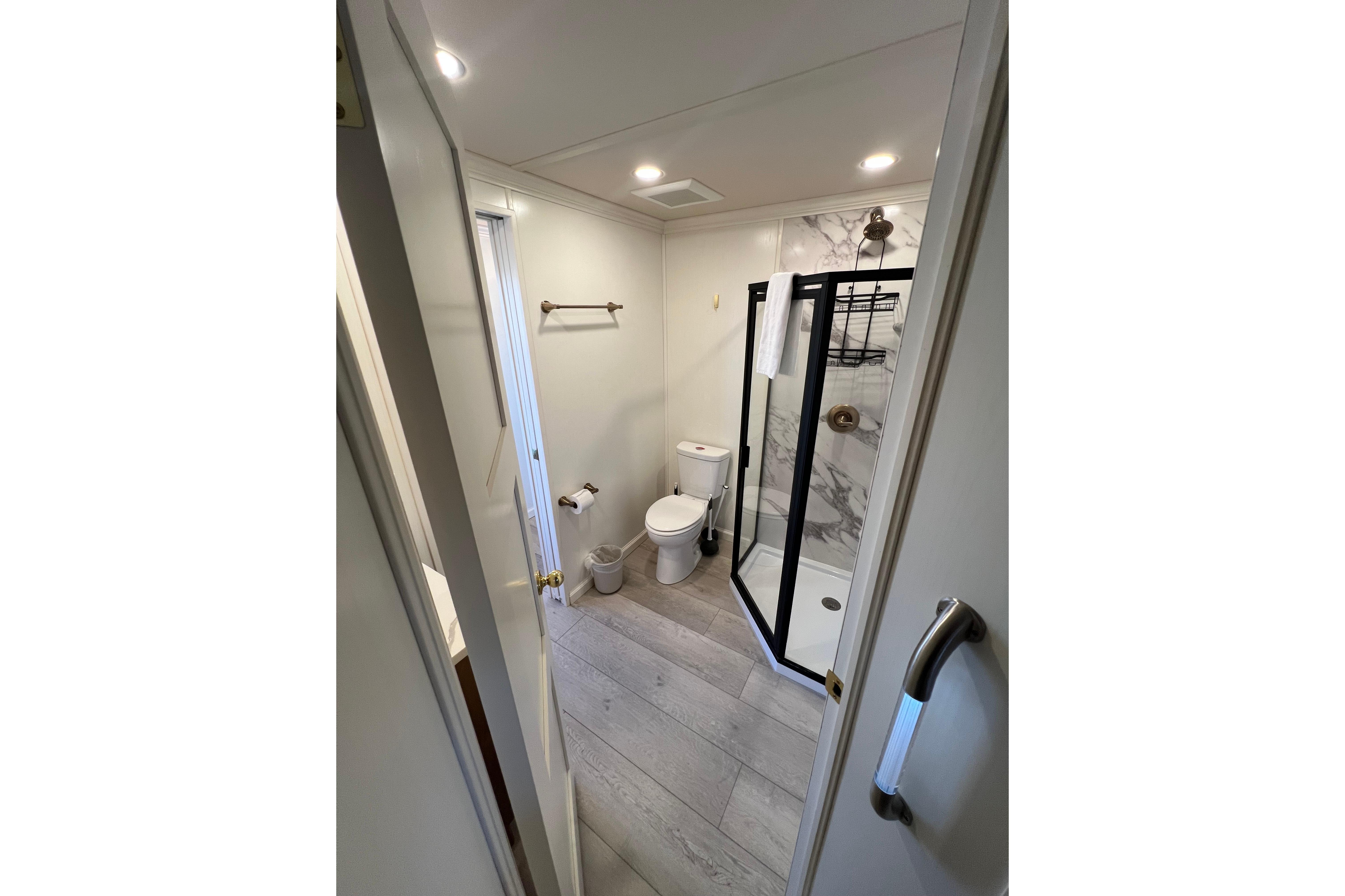 Modern bathroom in 2025 Sumerset Excellence Multiple Shares houseboat, featuring sleek shower and toilet.
