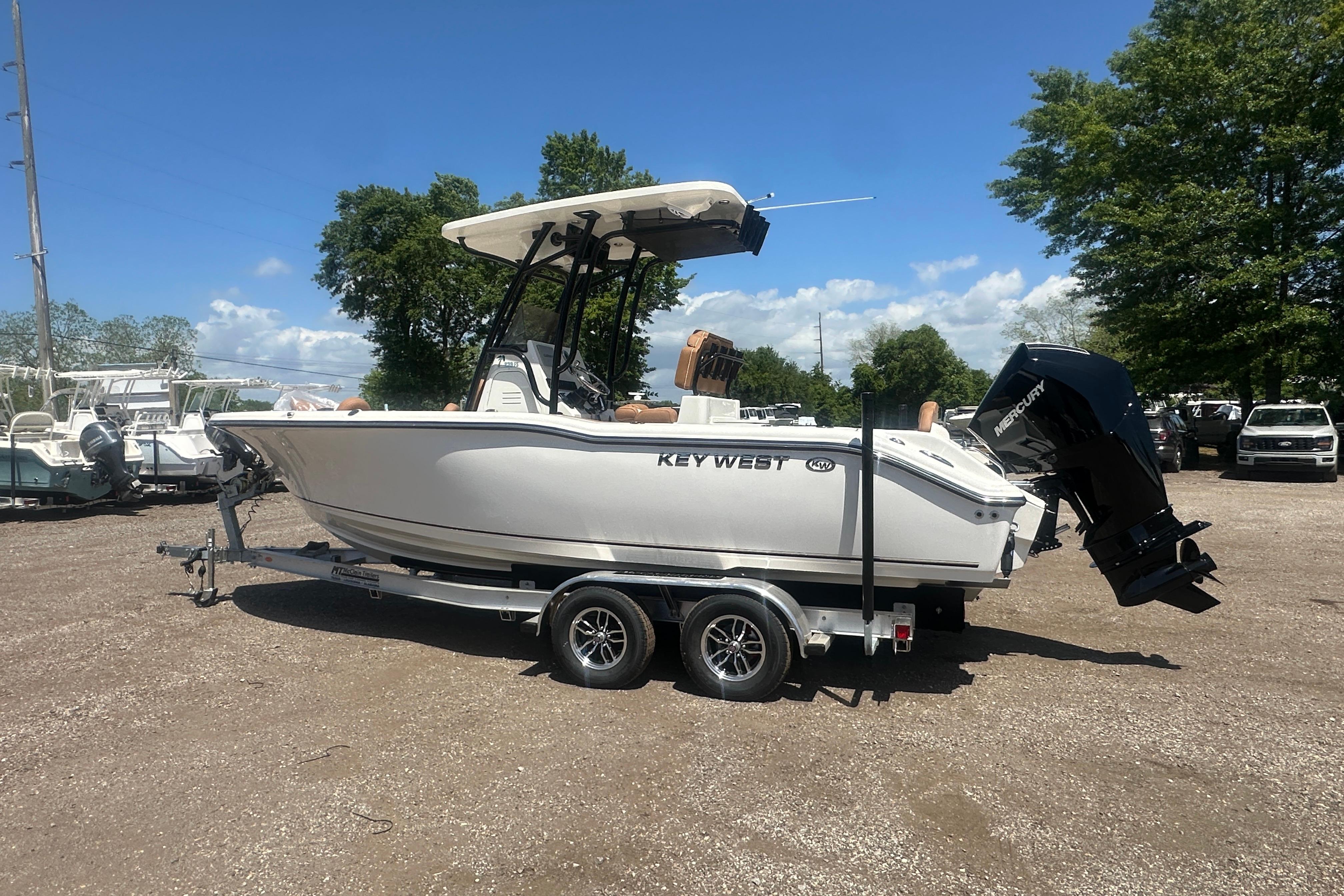 2026 Key West 239 FS boat on trailer, parked outdoors under clear sky.