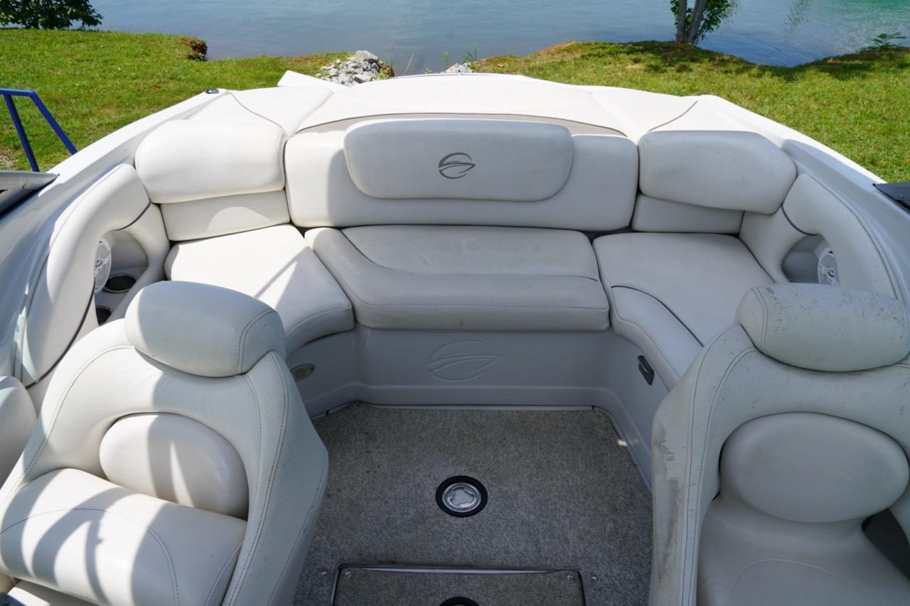 2004 Crownline 216 LS boat interior with white seating and lake view.