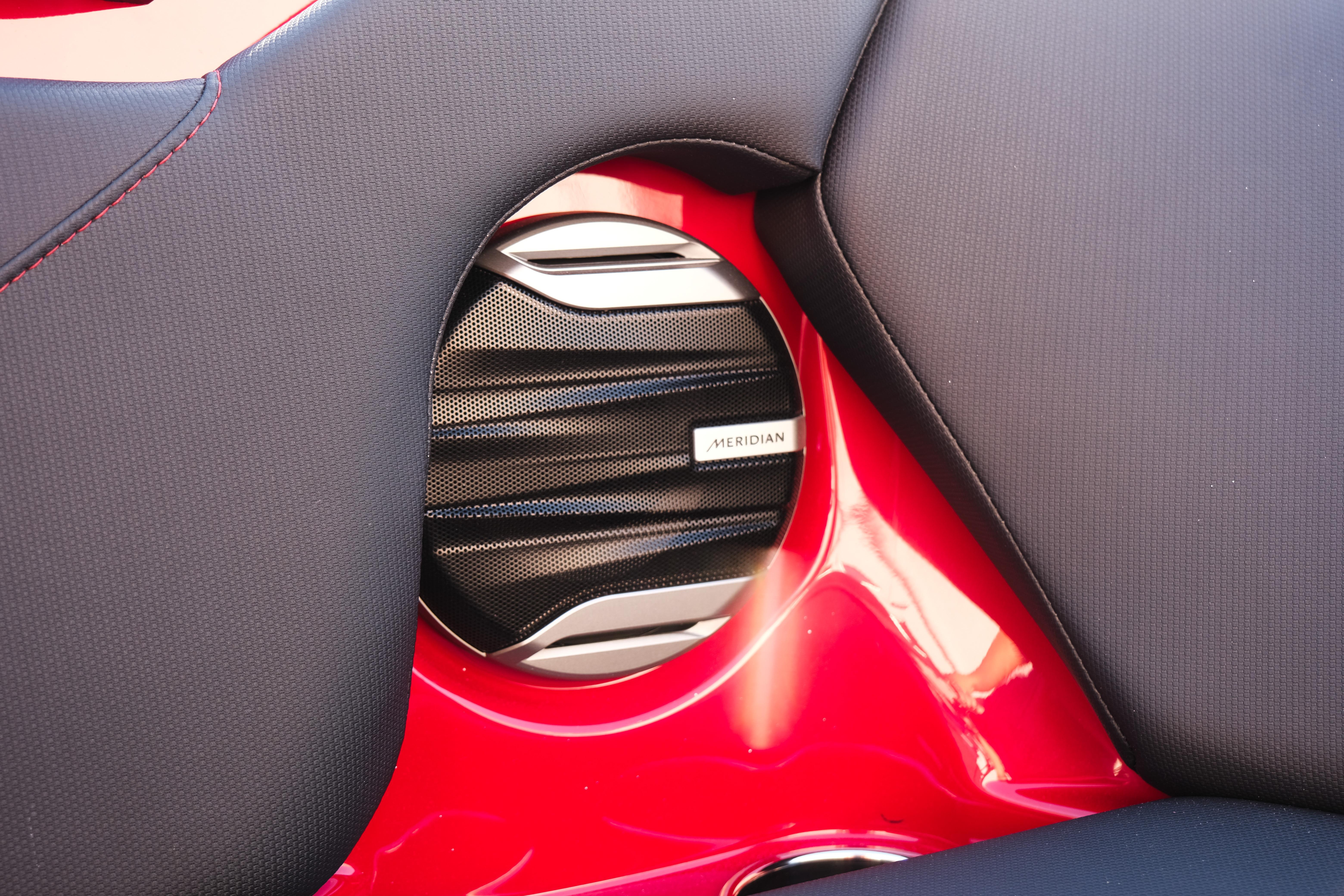Speaker detail in 2026 MasterCraft NXT22 boat with red and black interior.