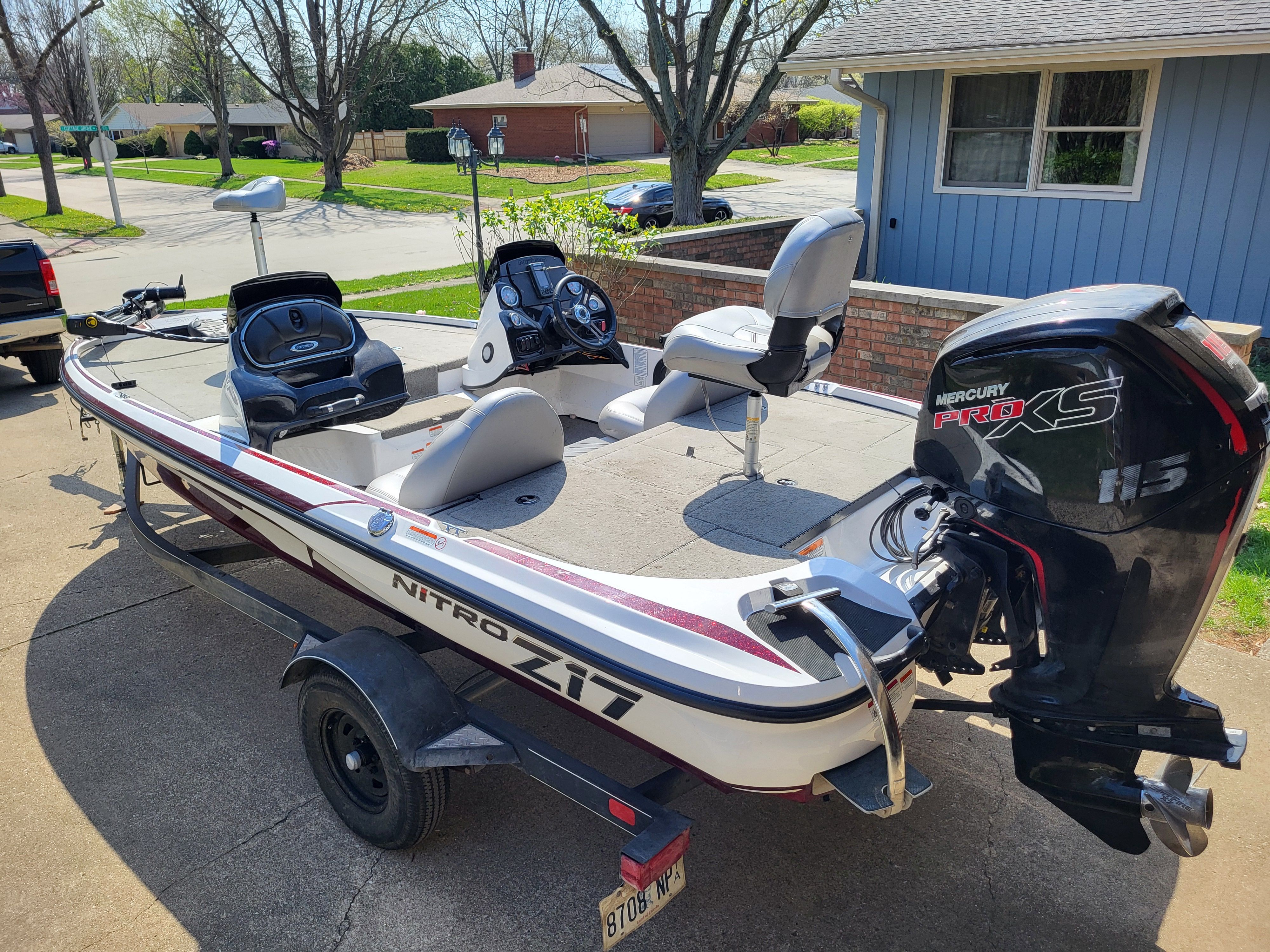 A 2017 Nitro Z17 boat on a trailer in a residential area.