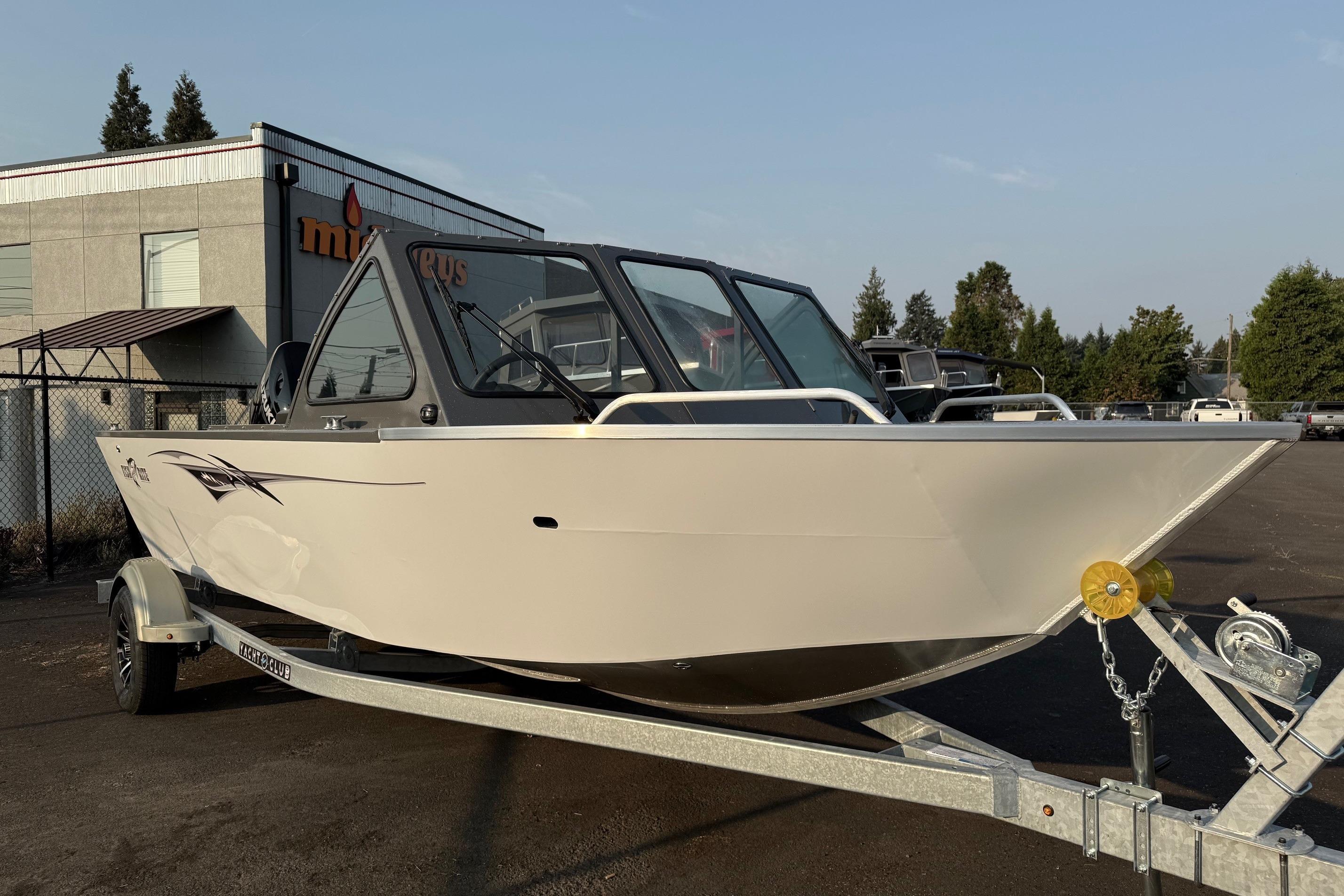 2026 Fish Rite Sportsman 20 boat on trailer, parked outdoors near a building.