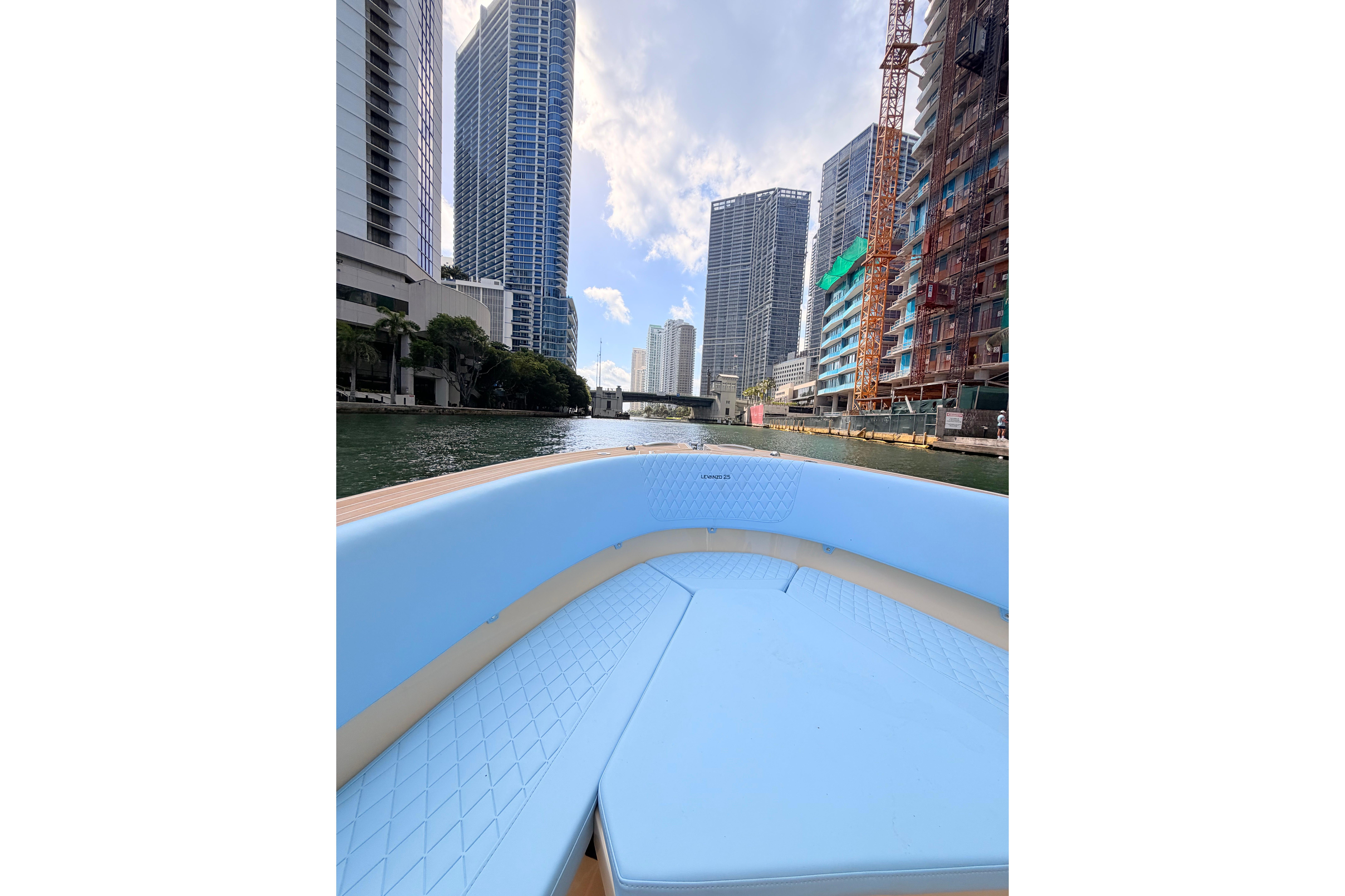 Lilybaeum Levanzo 25 boat cruising through cityscape with skyscrapers, 2026 model.