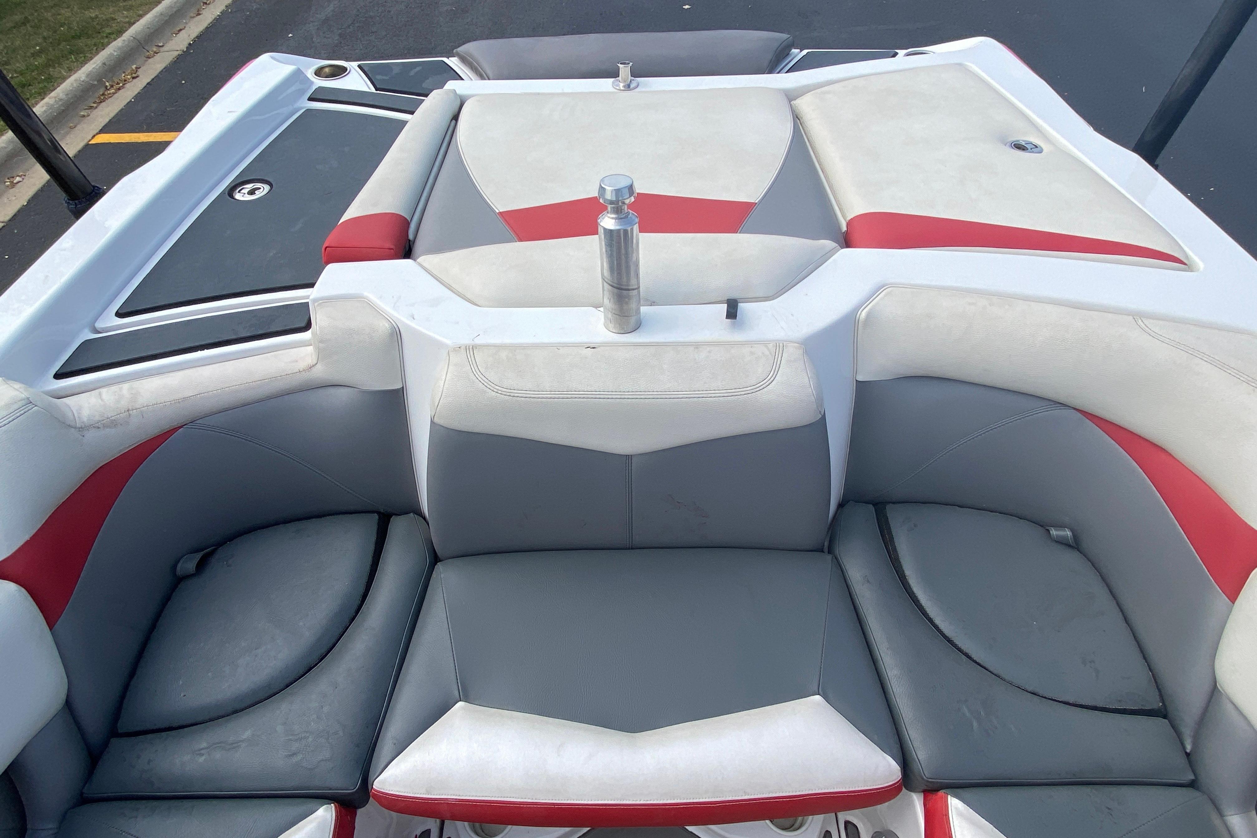 2014 Tigé R20 boat interior with gray and red seating, viewed from above.