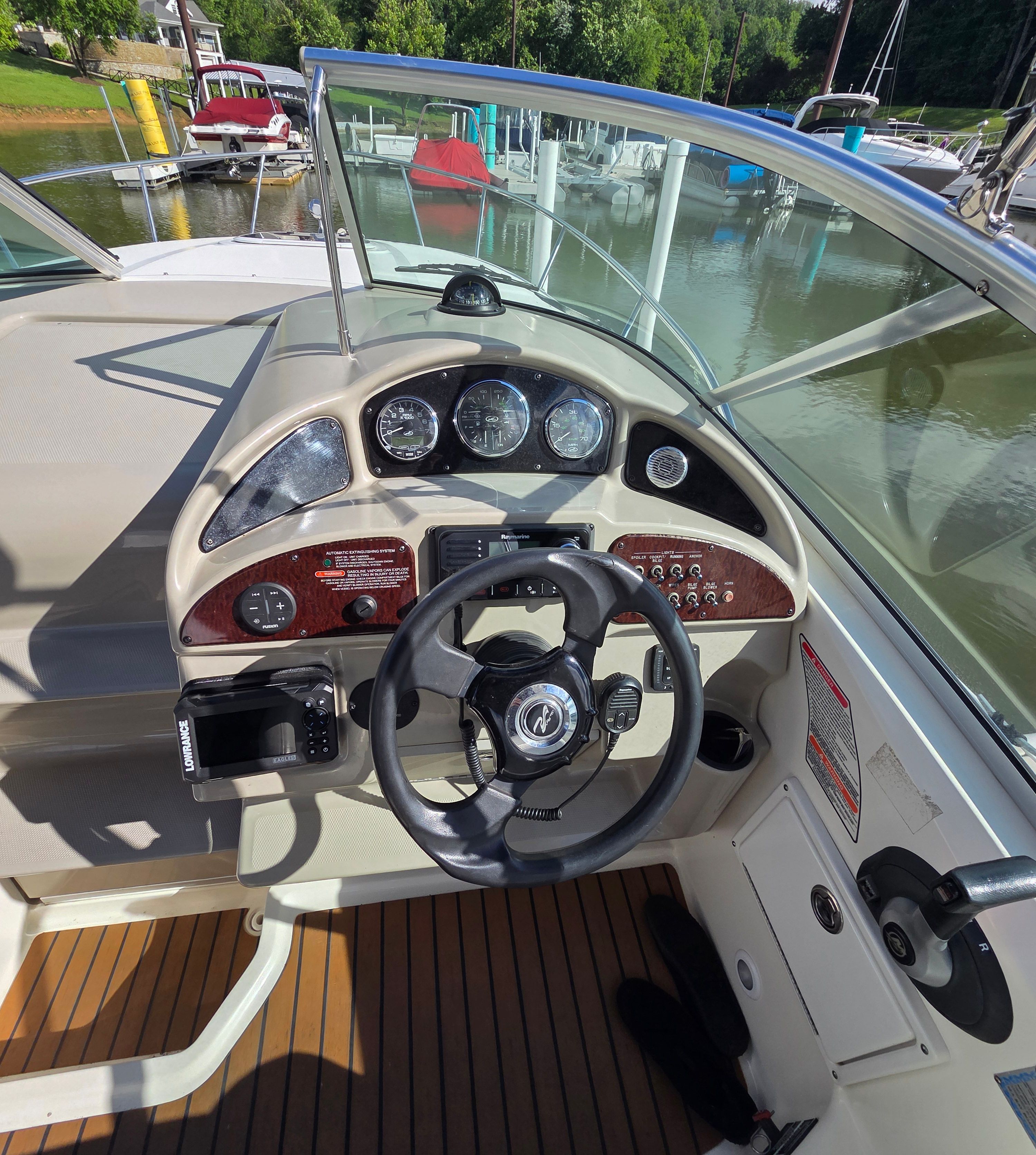 Helm of the 2005 Sea Ray Sundancer 260 with clear view of instruments and steering wheel.