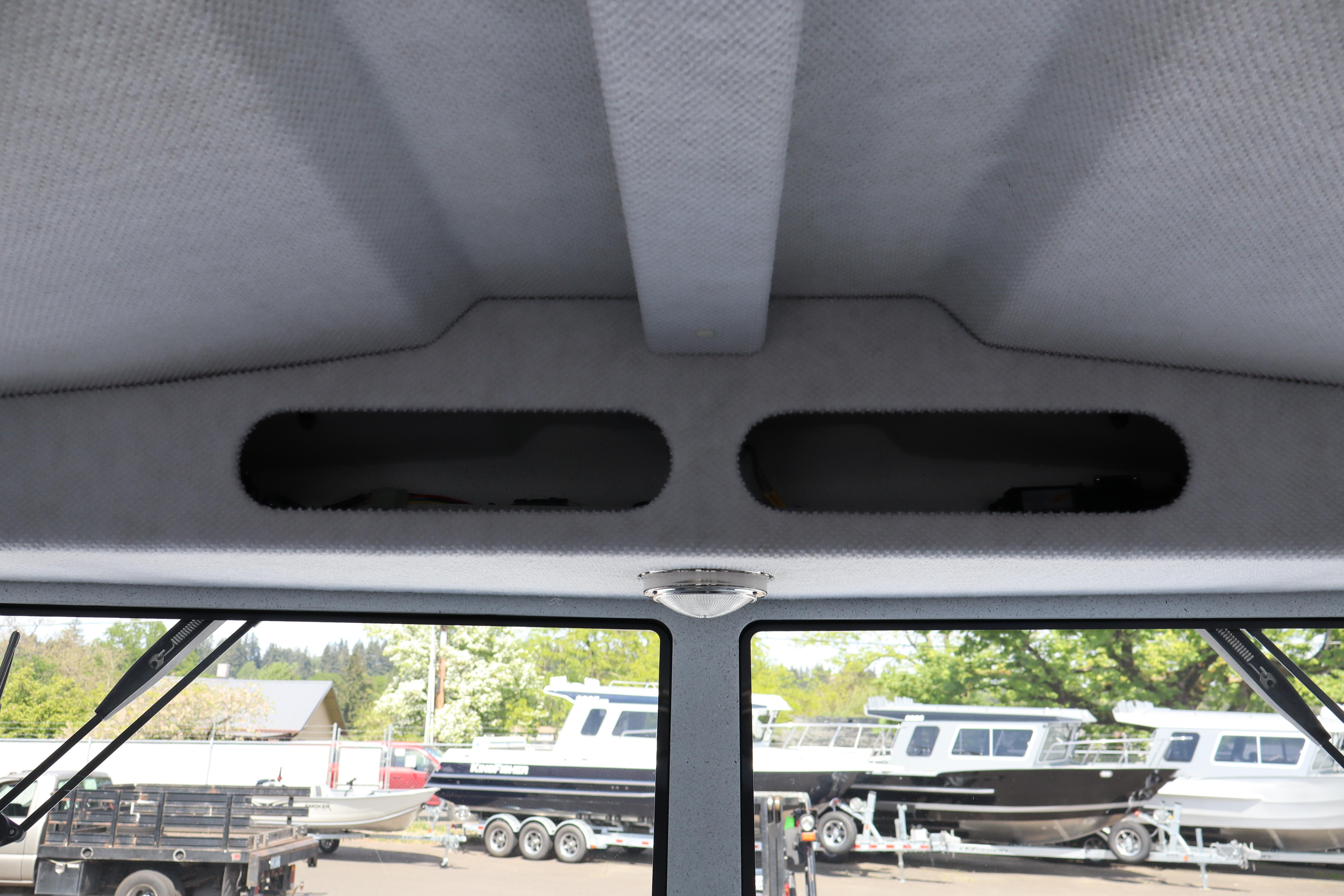 Interior view of 2026 KingFisher 25 XAC boat with overhead storage compartments.