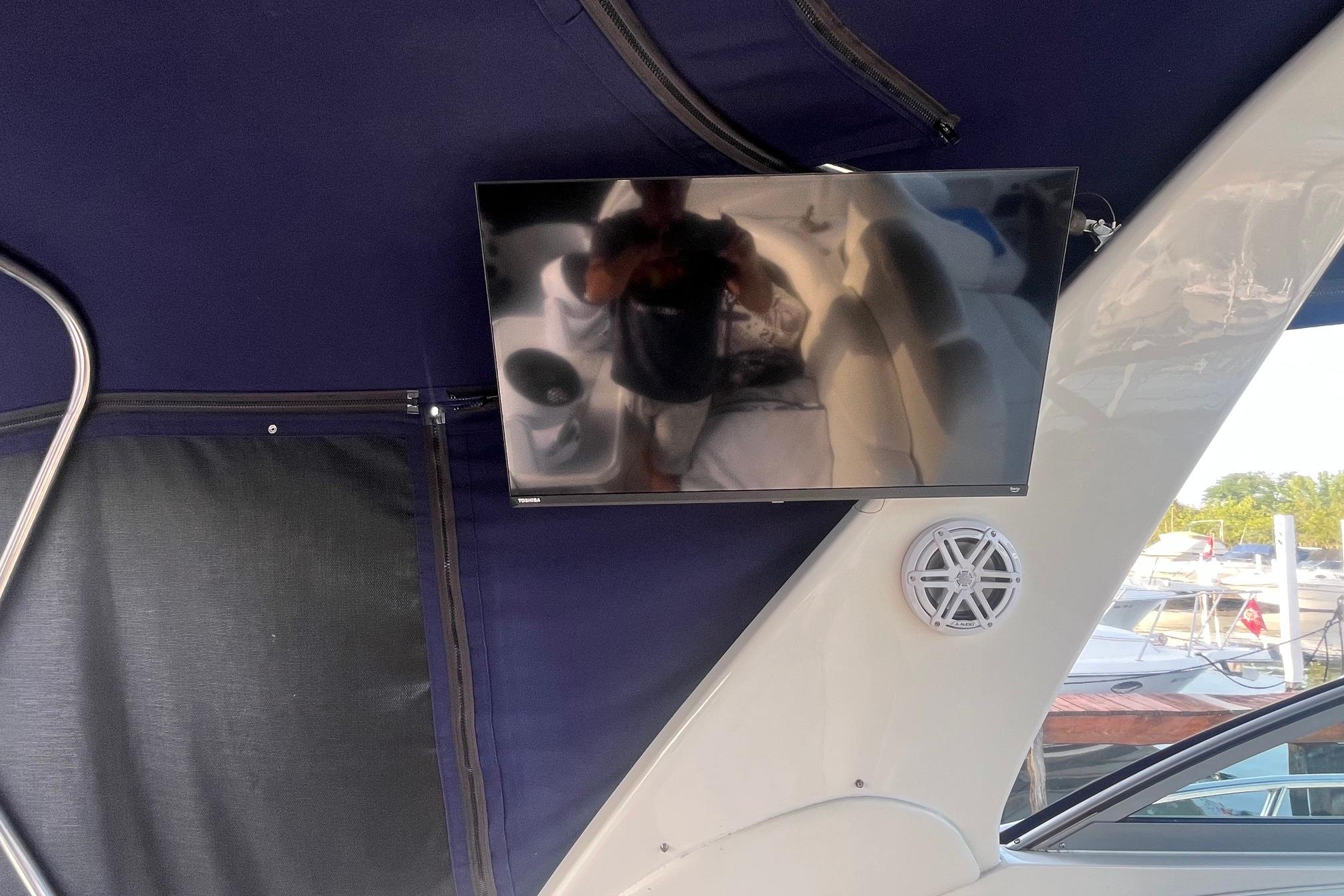 Flat-screen TV and speaker on 2001 Sea Ray 340 Sundancer boat interior.