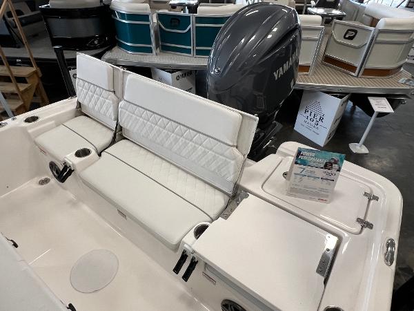 2024 Sea Fox 231 Bay boat with Yamaha engine, white seating, and storage compartments.