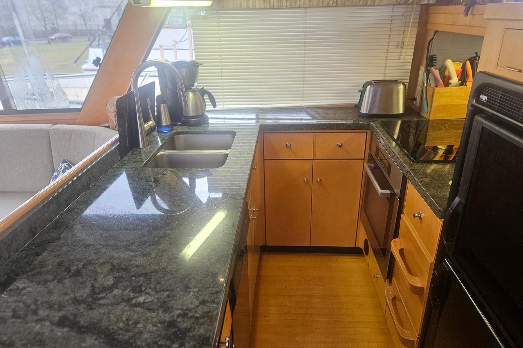 Modern yacht kitchen with granite countertops, stainless steel sink, and appliances, Symbol 55, 1995 model.