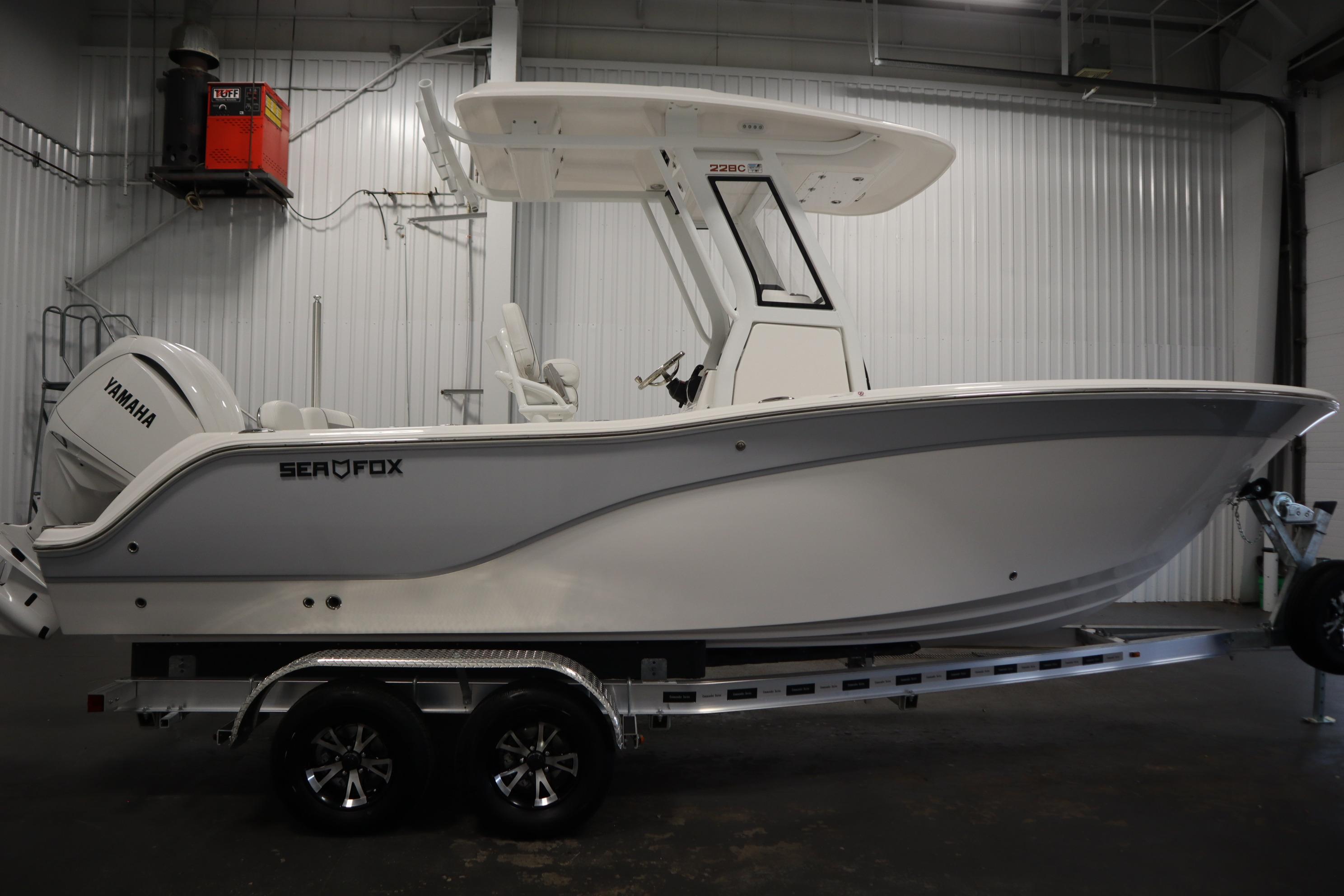 2026 Sea Fox 228 Commander boat on trailer in indoor storage.
