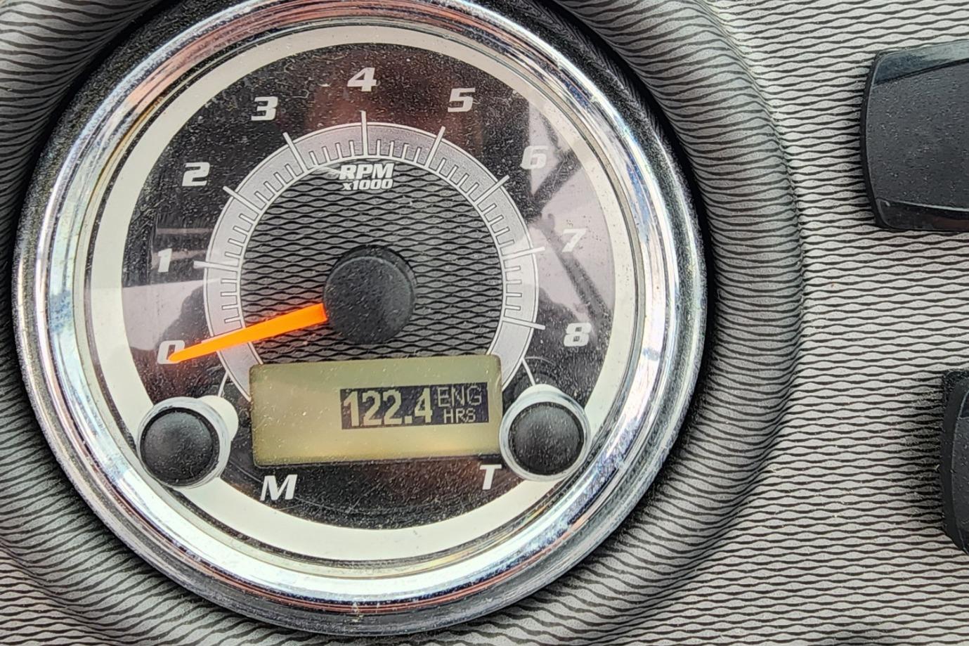 Close-up of 2015 Yamaha Boats 212X tachometer showing 122.4 engine hours.