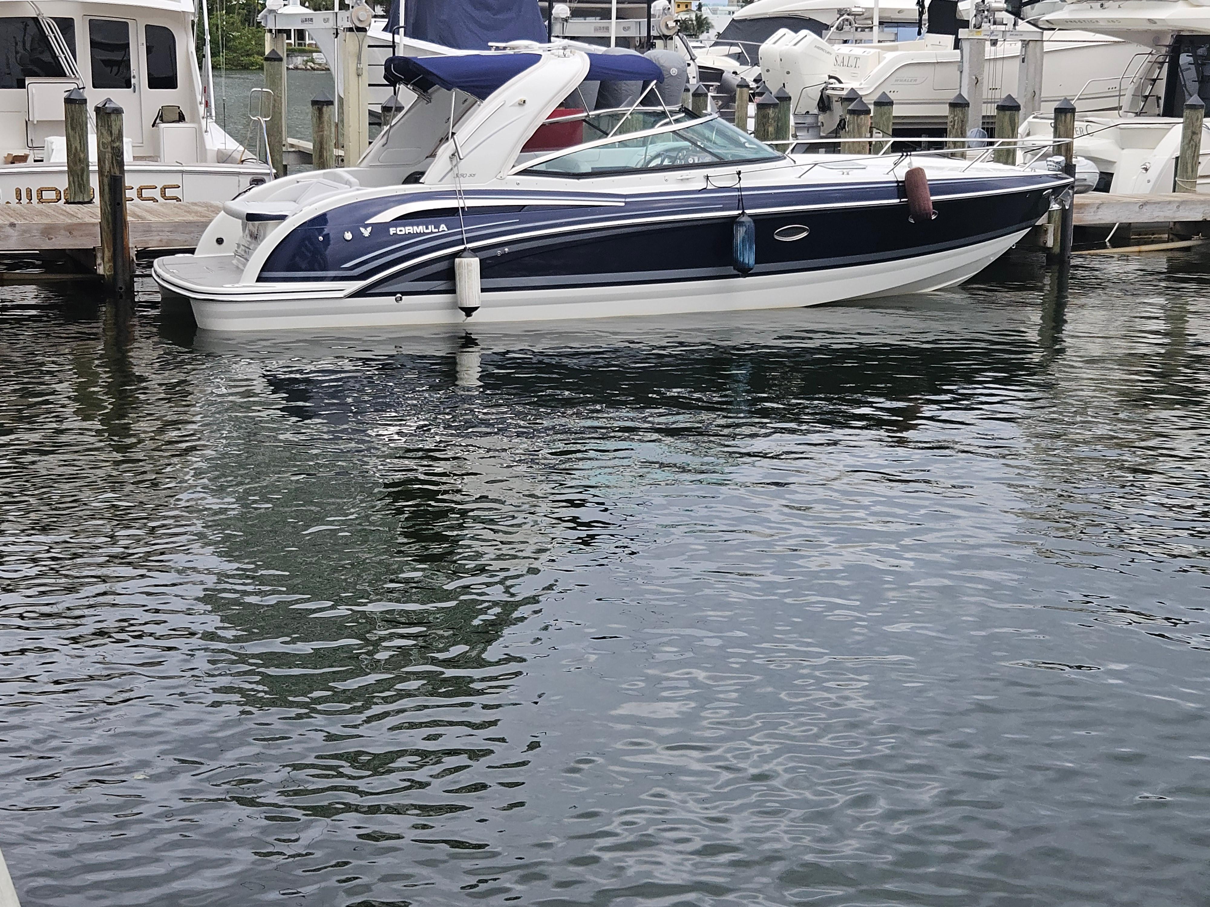 2018 Formula 350 Sun Sport boat docked in marina.