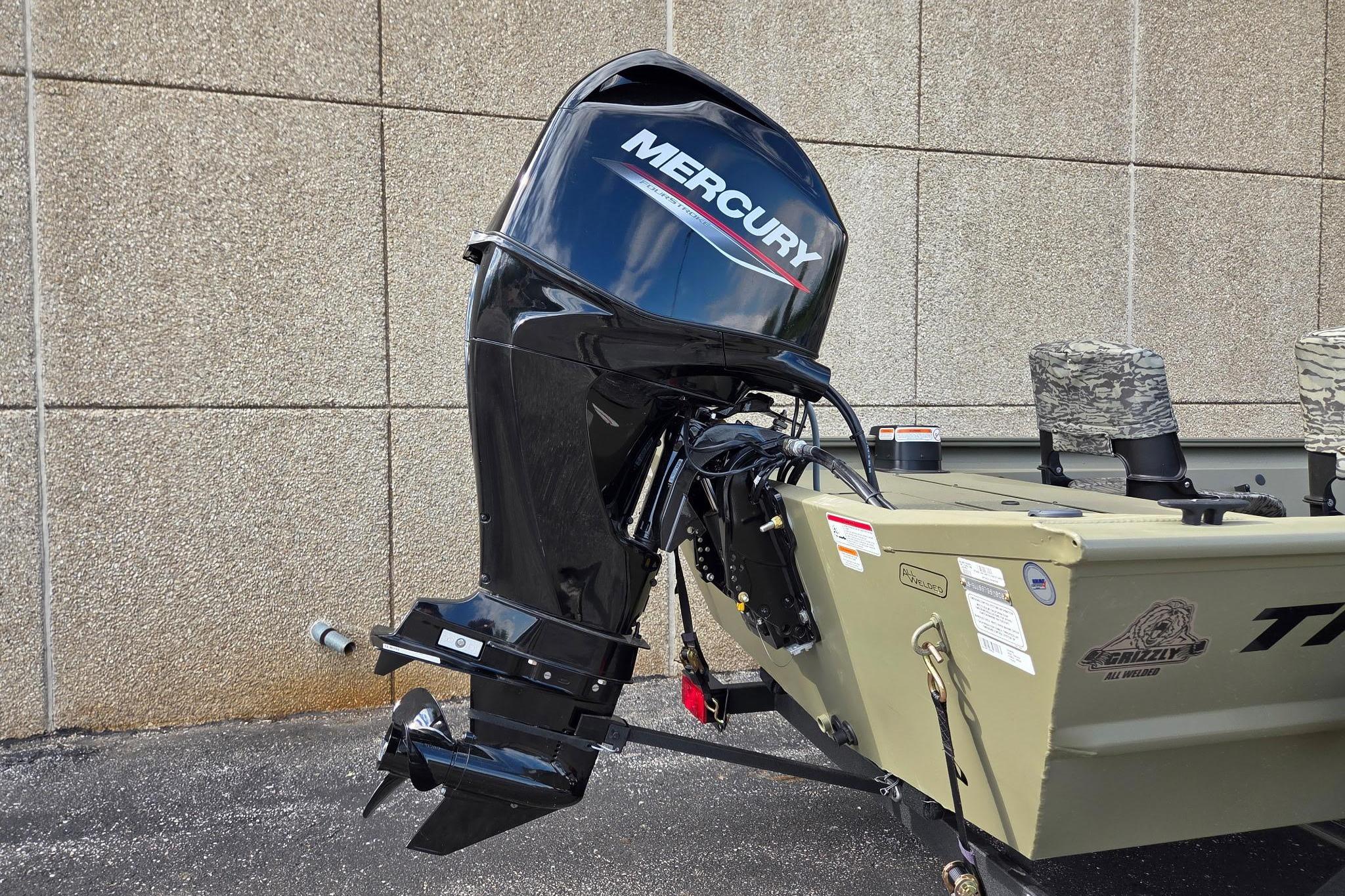 2026 Tracker Grizzly 1754 SC boat with Mercury outboard motor, parked outdoors.