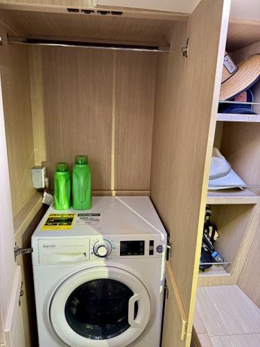 Laundry area with washing machine and detergent in Aquila 44, 2022 model.