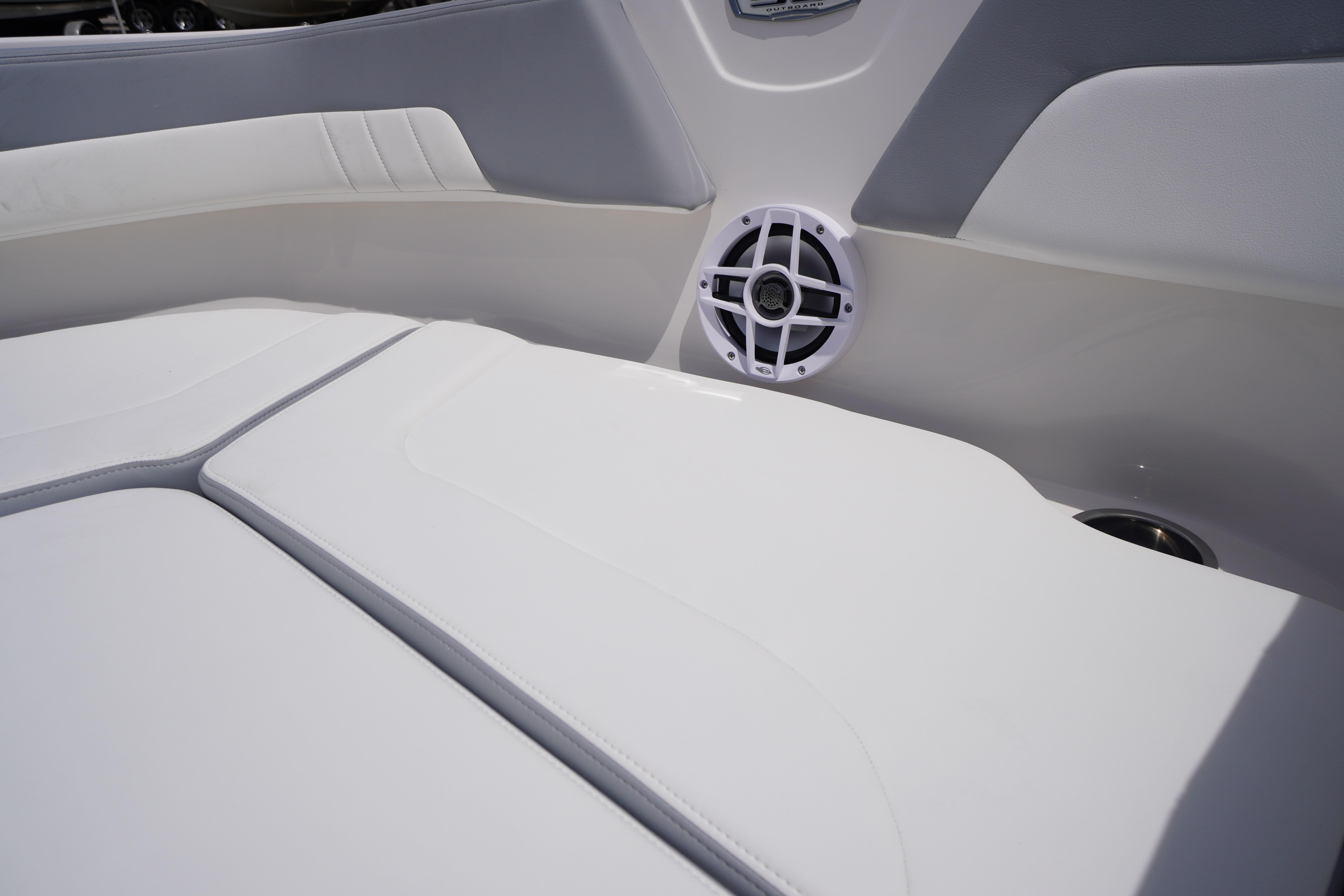 Interior of 2026 Chaparral 23 SSi OB boat with white seating and speaker.