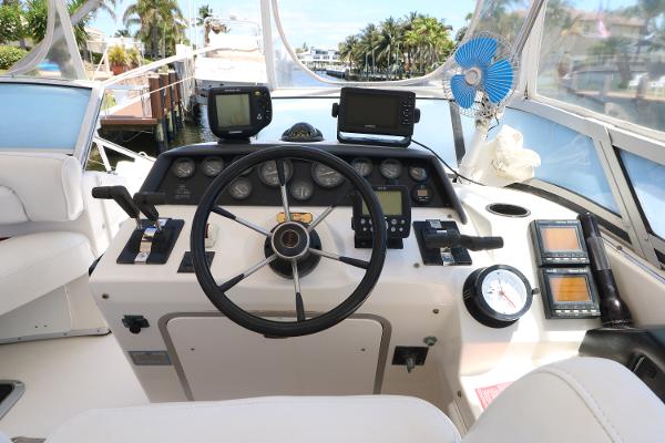 1992 Sea Ray 350 Express Bridge helm with steering wheel and navigation instruments.