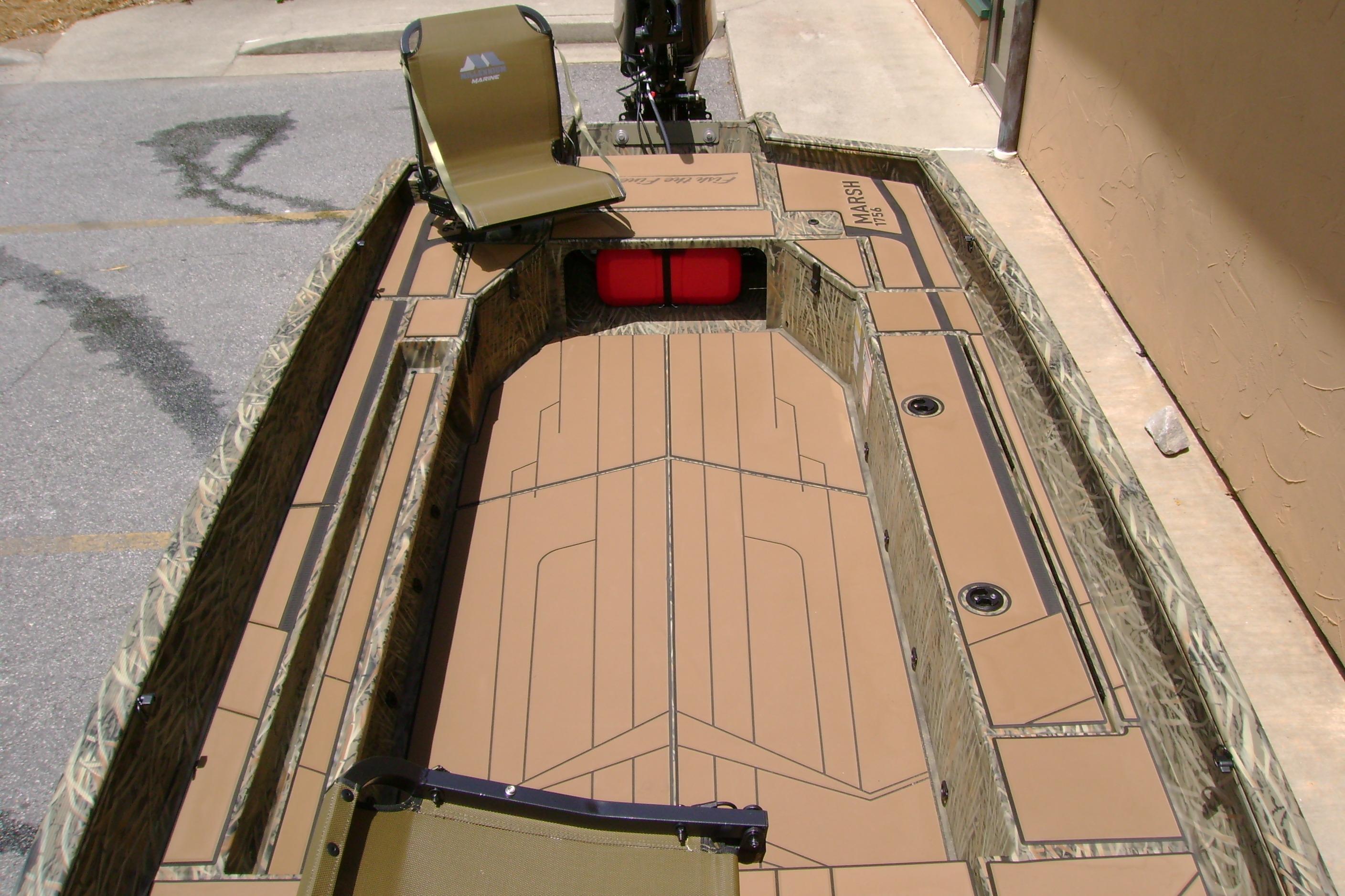 2026 Tracker Grizzly 1756 T Marsh boat interior with camouflage design and seating.