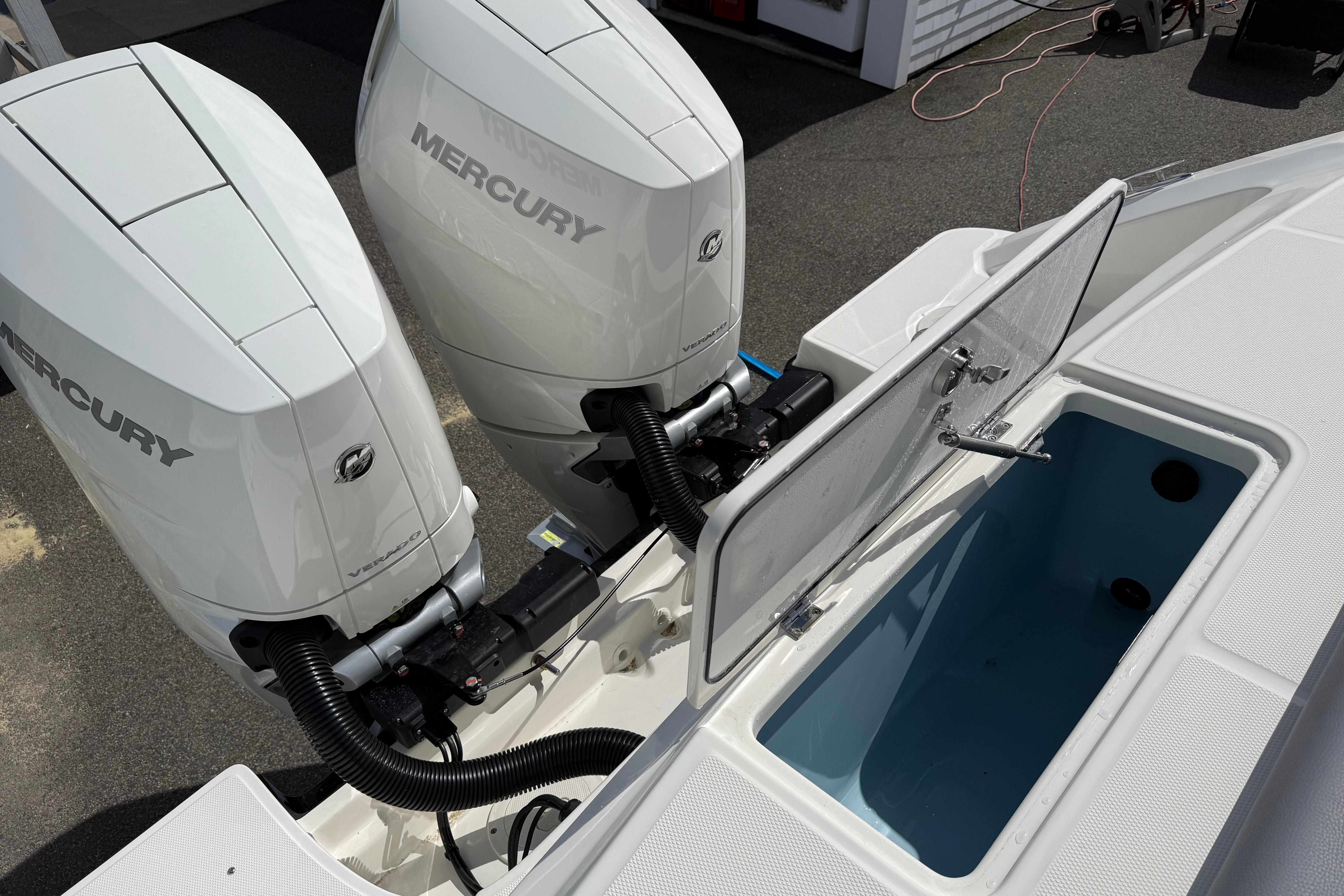 2026 Boston Whaler 330 Outrage with dual Mercury engines and open storage compartment.