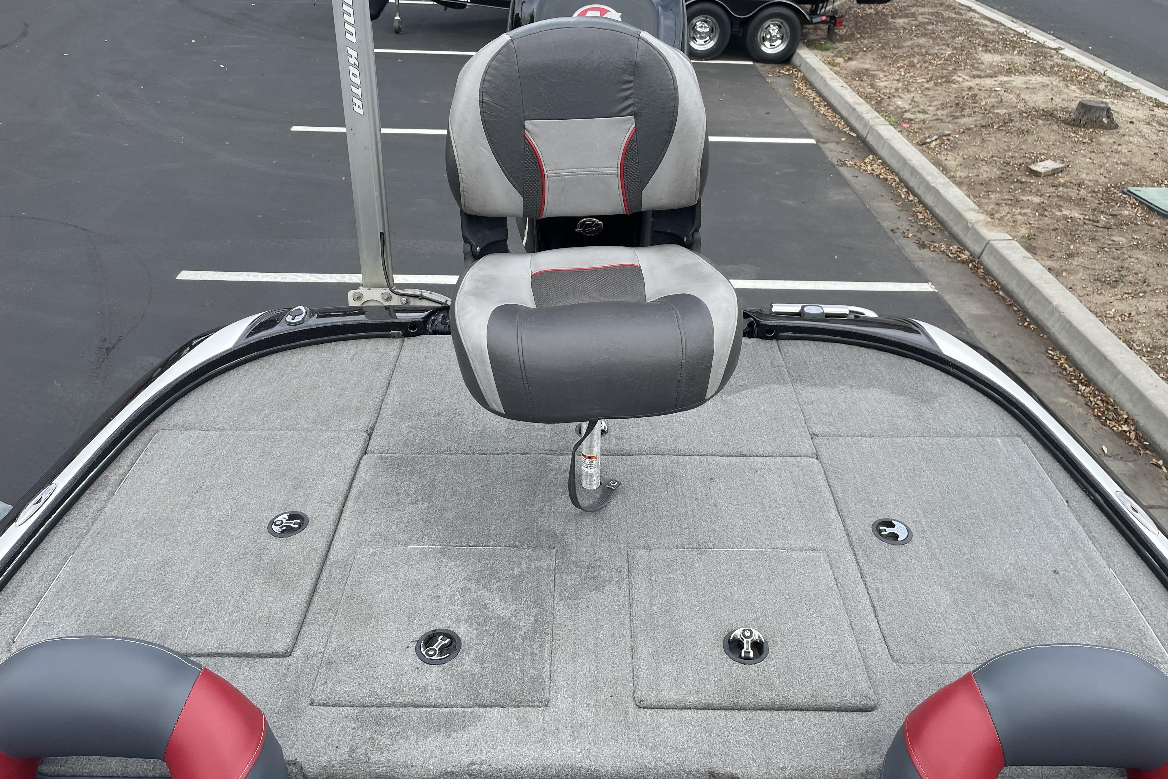 2013 Nitro Z-8 boat deck with gray and red seating in a parking lot.