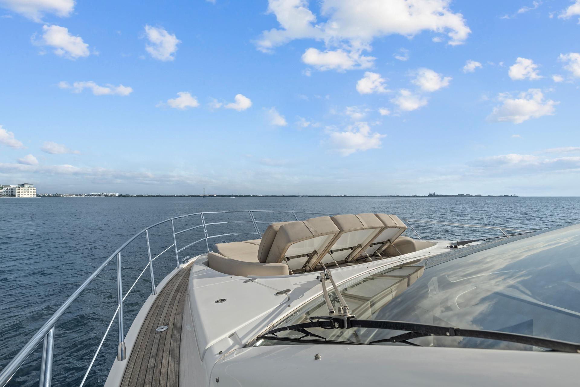 Luxury Azimut 55 yacht cruising on open water under a clear blue sky.