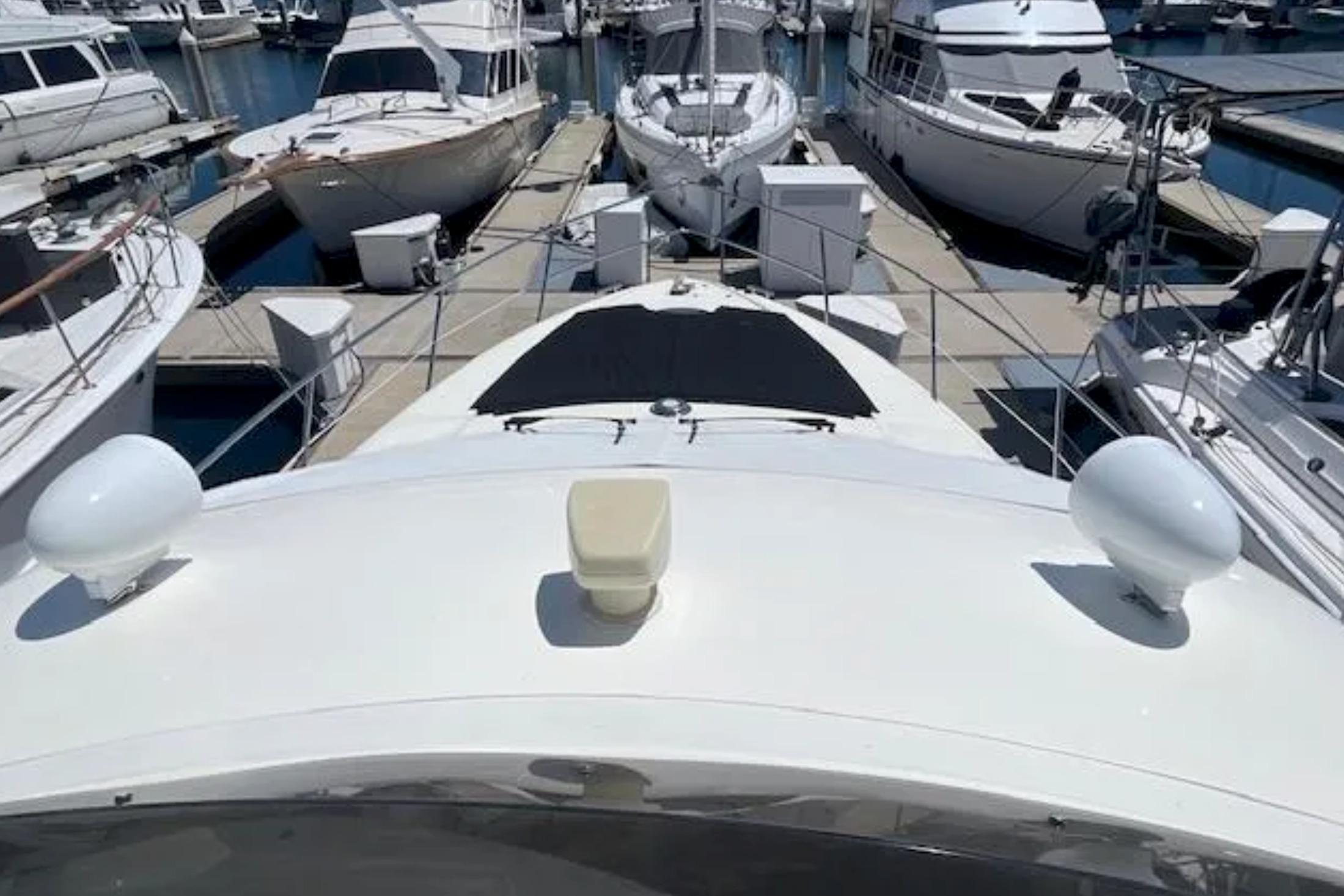 2004 Azimut 46 yacht docked among other boats in a marina.
