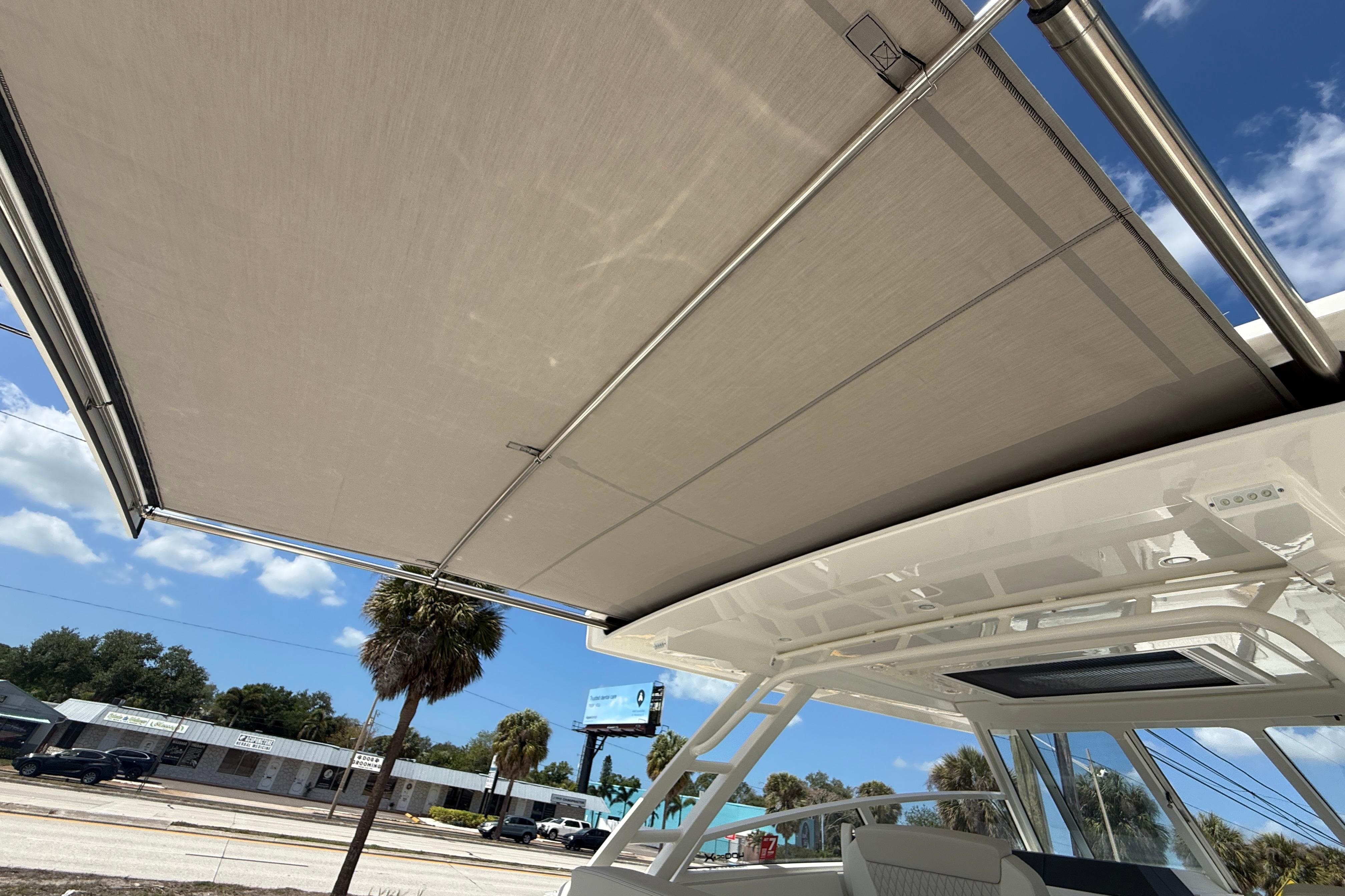2026 World Cat 400 DC-X Island boat with extended sunshade canopy.