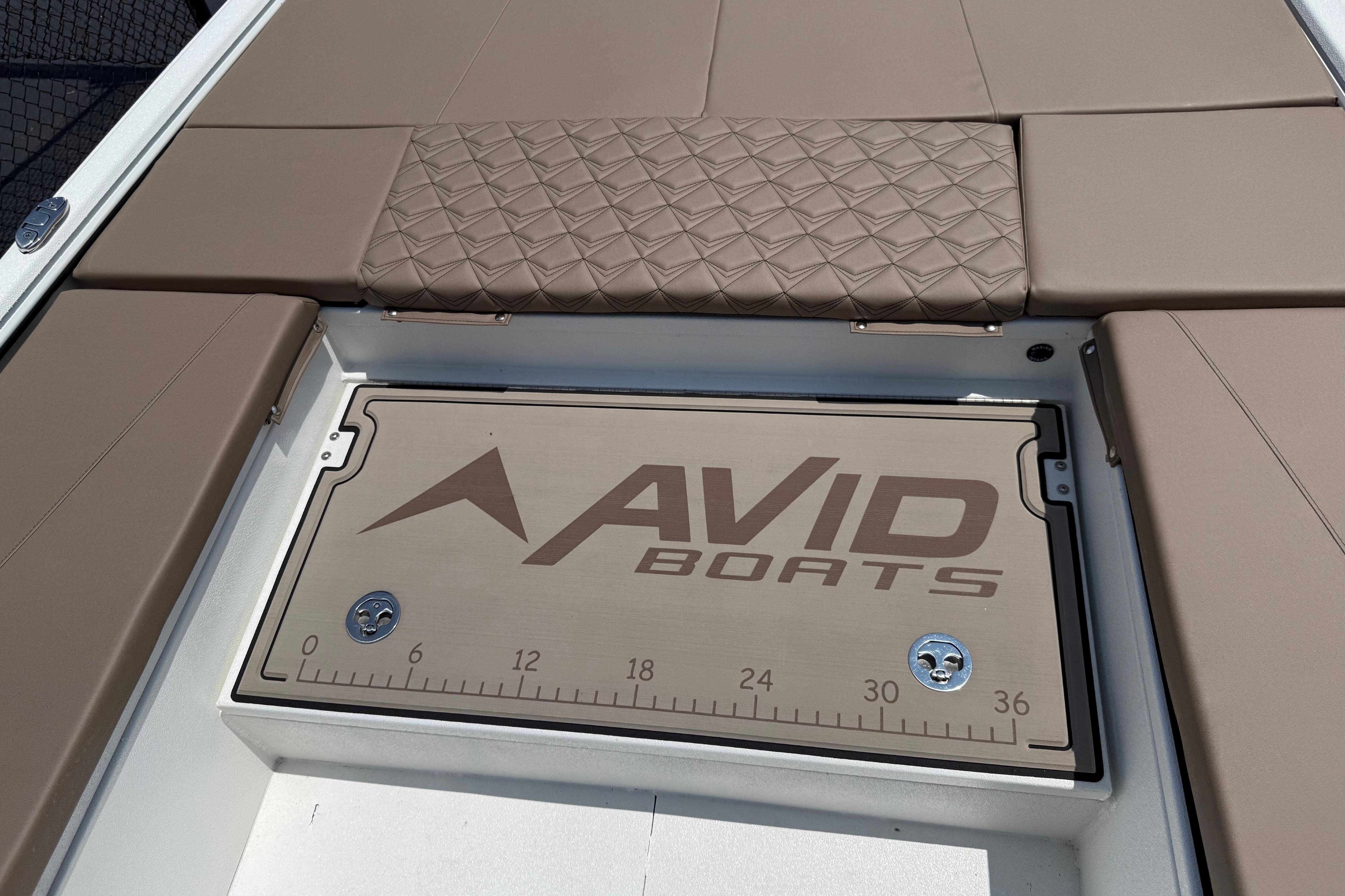 2025 Avid 22 Recon boat deck with cushioned seating and branded storage compartment.