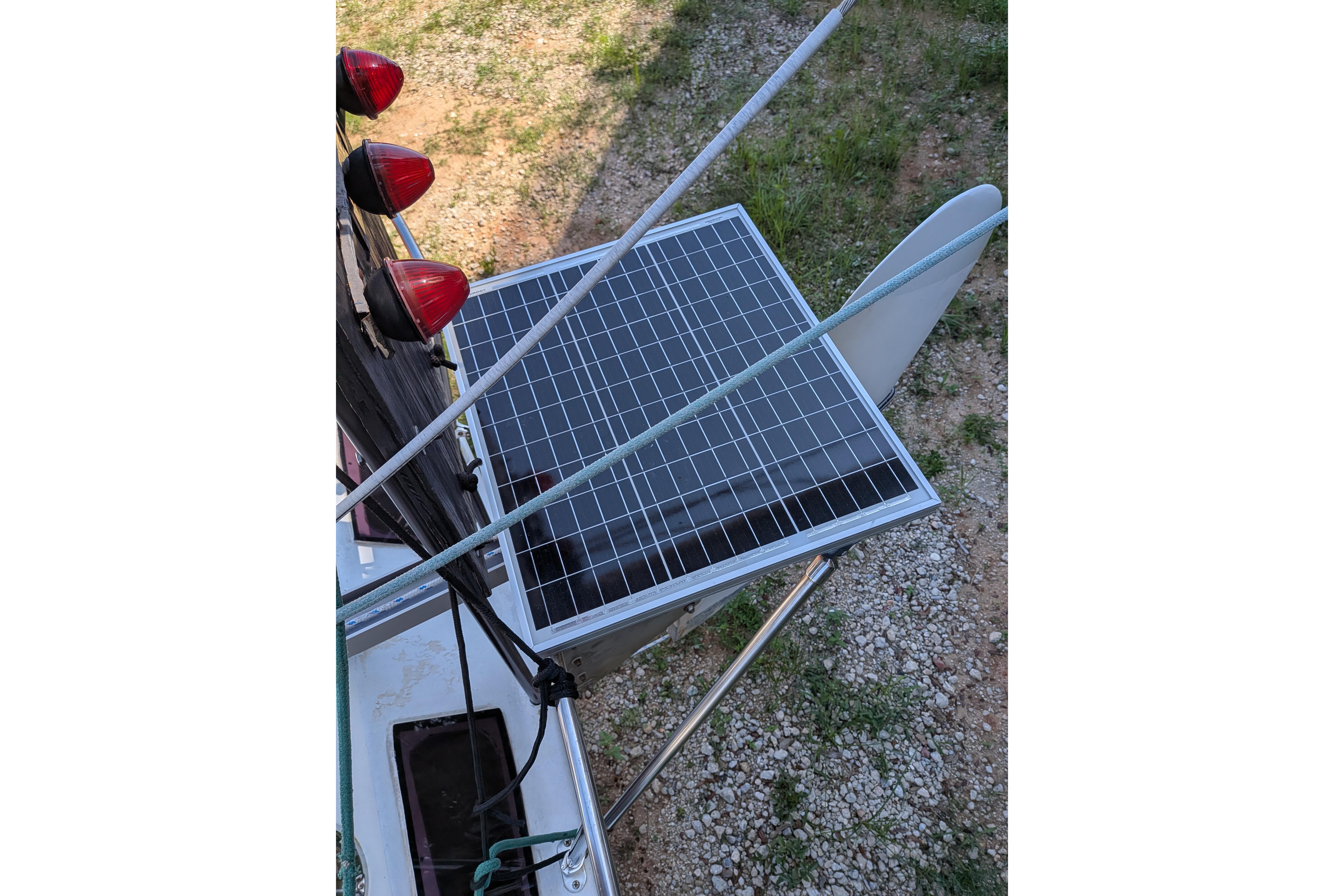 Solar panel on 1991 Corsair F-27 sailboat, with red navigation lights and rigging visible.
