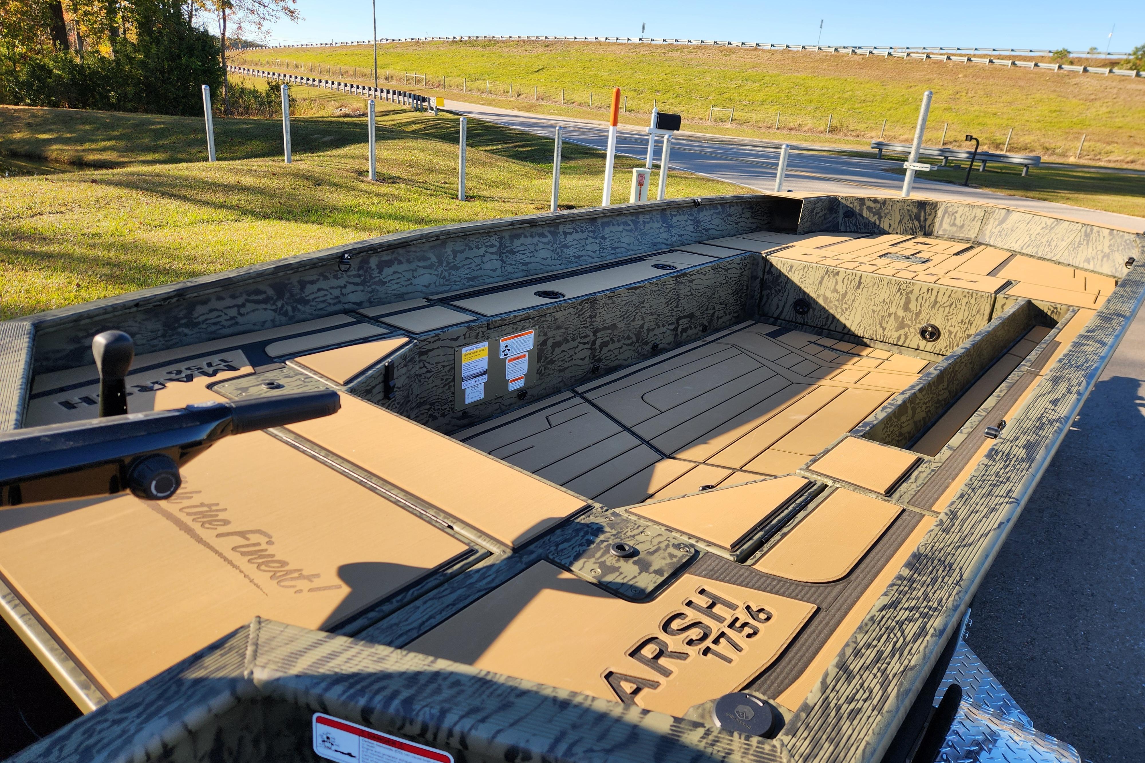 2026 Tracker Grizzly 1756 T Marsh boat with camo design, parked outdoors.