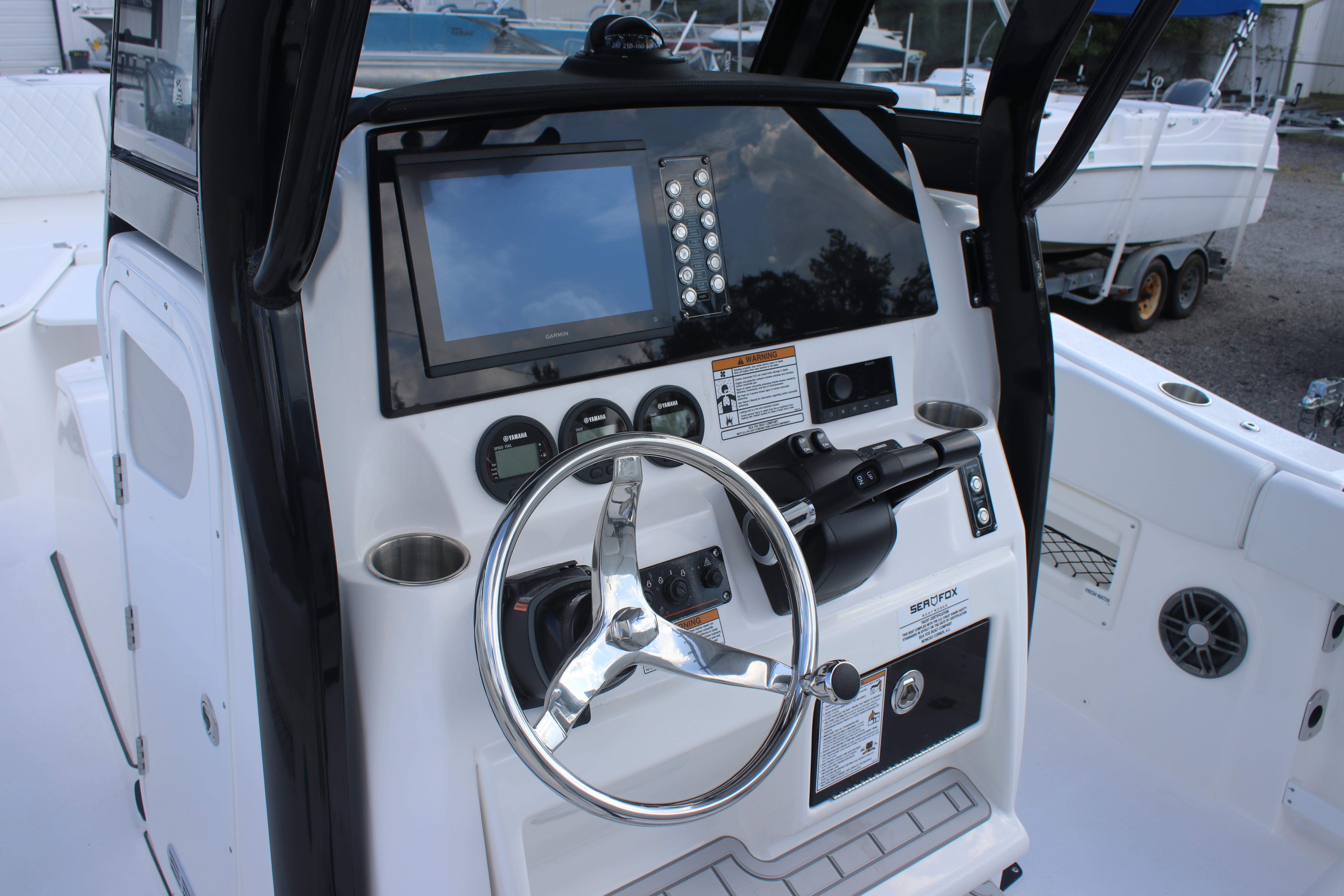 2026 Sea Fox 268 Commander boat dashboard with steering wheel and control panel.