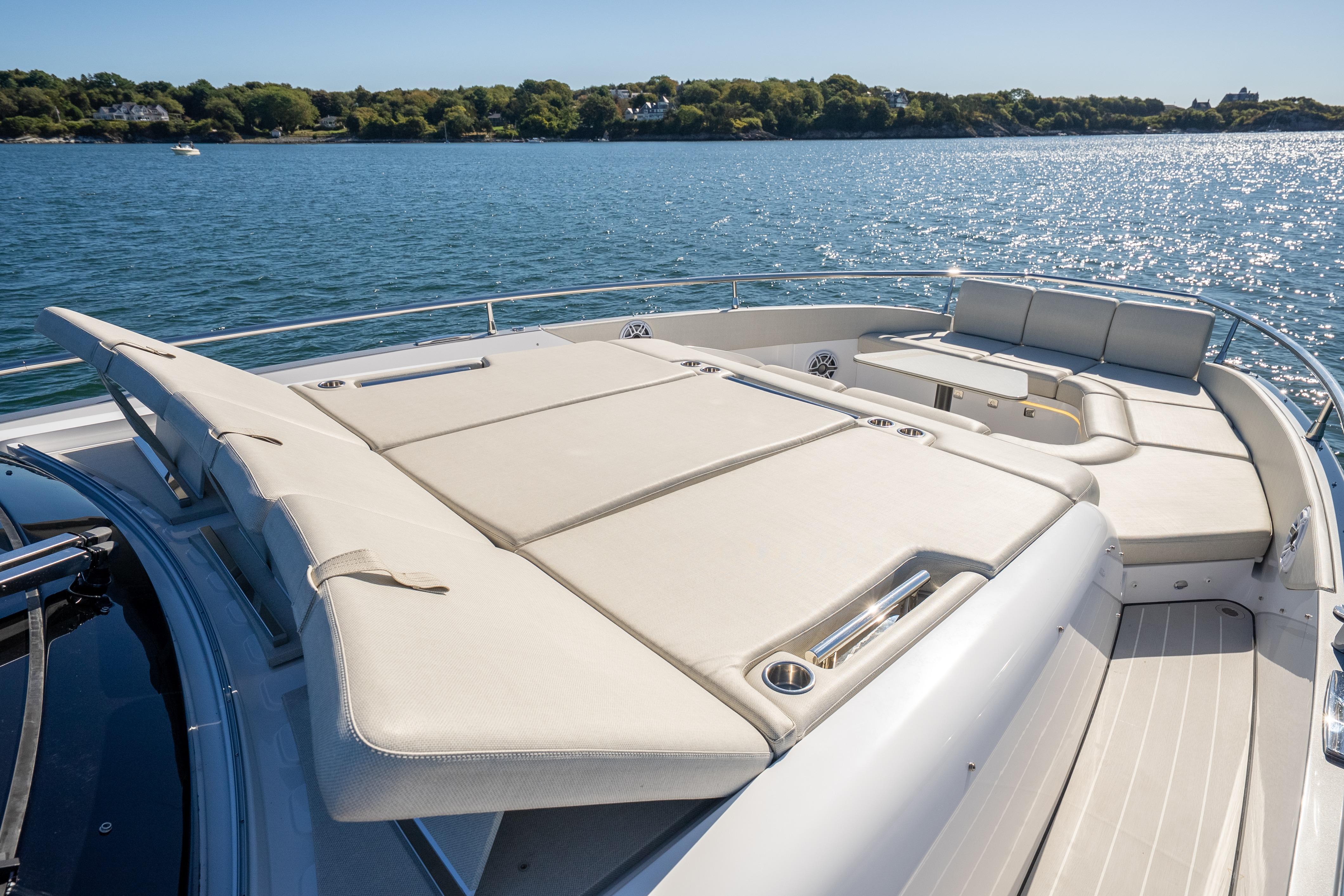 Luxurious 2023 Azimut Verve 47 yacht with spacious sunbathing deck on serene water.