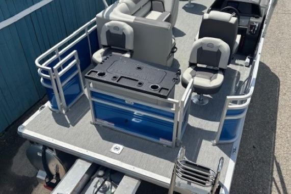 2026 Sun Tracker Fishin' Barge 20 DLX pontoon boat with seating and fishing station.